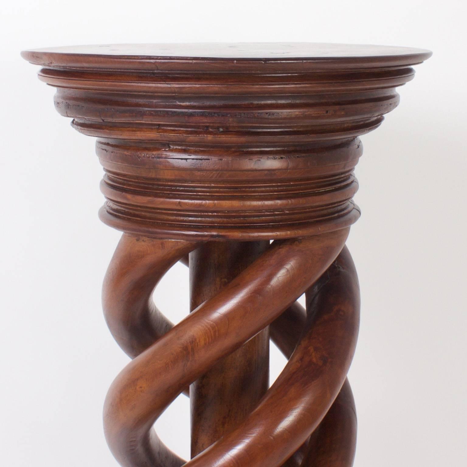 Rugged, antique pedestal with a helix twist design that defies comparison. The stand is ambitiously carved from mahogany and features a multi layered turned capital and plinth. The large-scale and expert craftsmanship make this a rare and impressive