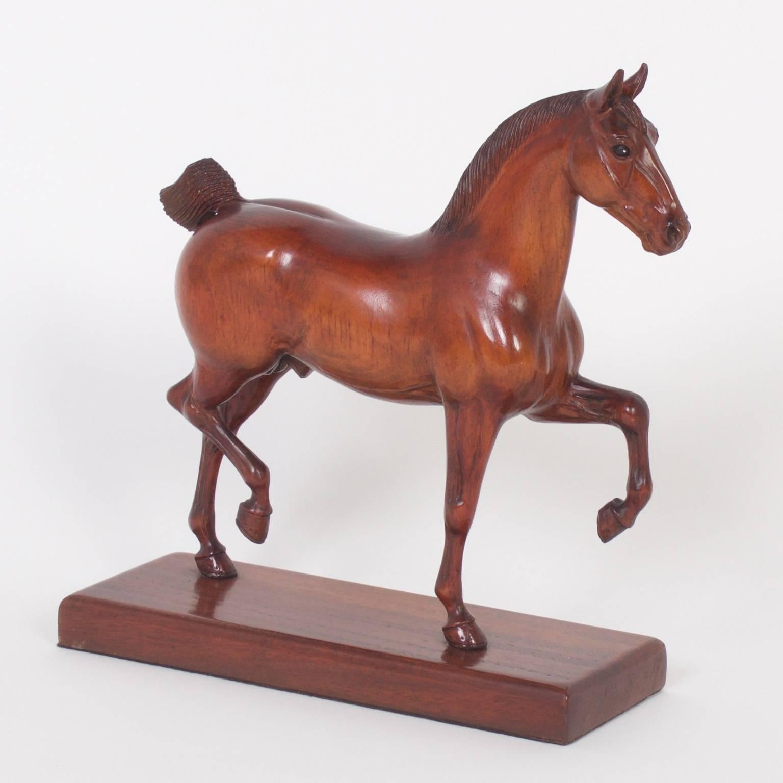Spirited pair of carved mahogany show horse models in mid strut. These sculptures capture the essential power and elegance these majestic animals hold. 3709 C signed P. Giba on the base. Price for this horse is $2,350. Priced individually.
 
