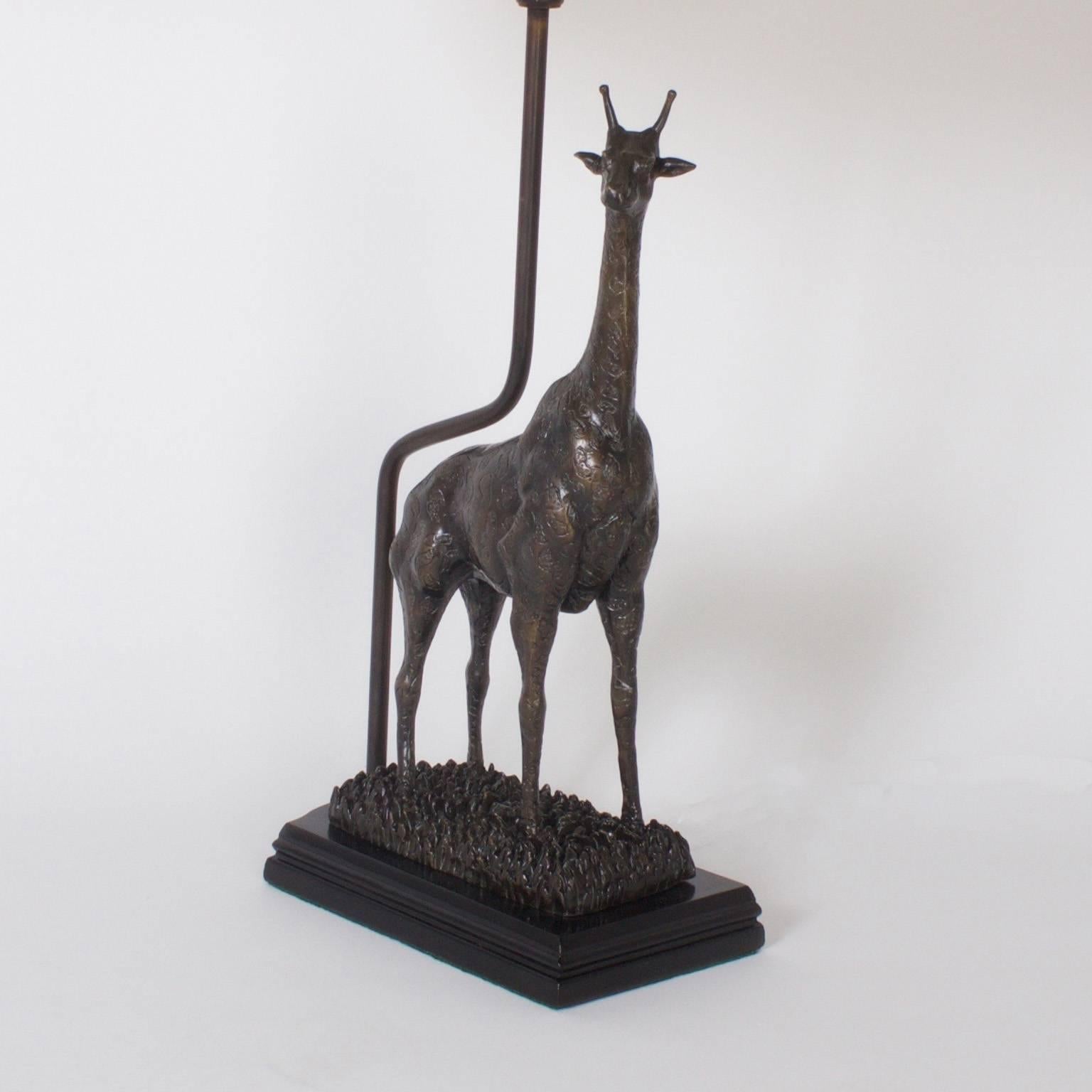 Handsome pair of giraffe table lamps depicting the power and grace of these curious animals. Crafted in the Mid-Century with bronze and presented on ebonized bases. These lamps cross over many style and time lines with aplomb.
Newly wired.