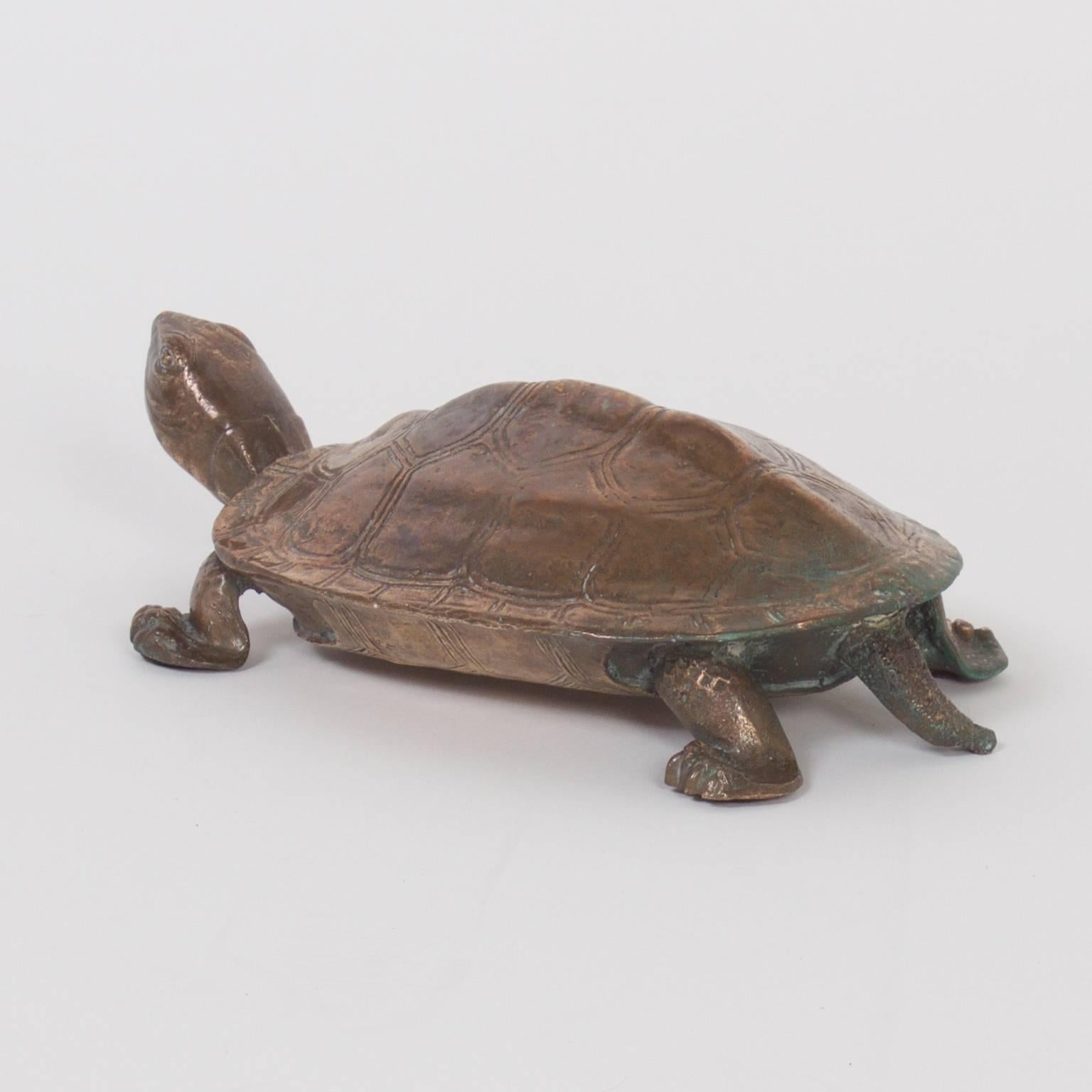 The turtle, long a subject of fascination, is presented here cast in bronze with a mellow luster and slight verdigris finish. Rustic details on the top and bottom.