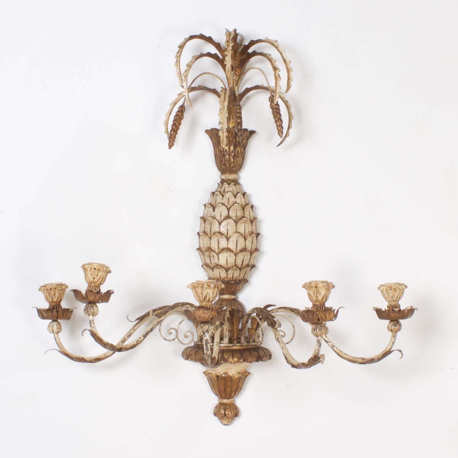 Here is a bit of decorative old world charm. A pair of carved wood and metal Italianate, pineapple sconces with a perfectly distressed white and gold finish. These wall sconces are the best of this genre. 

  