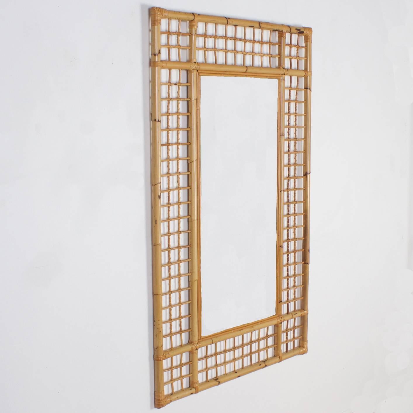 Handsome large scale Mid-Century rectangular mirror and frame crafted with bamboo and rattan, attributed to Thayer Coggin, featuring a strong no nonsense geometric design. Perfect for an Island, coastal or any vibe that deserves a hip tropical
