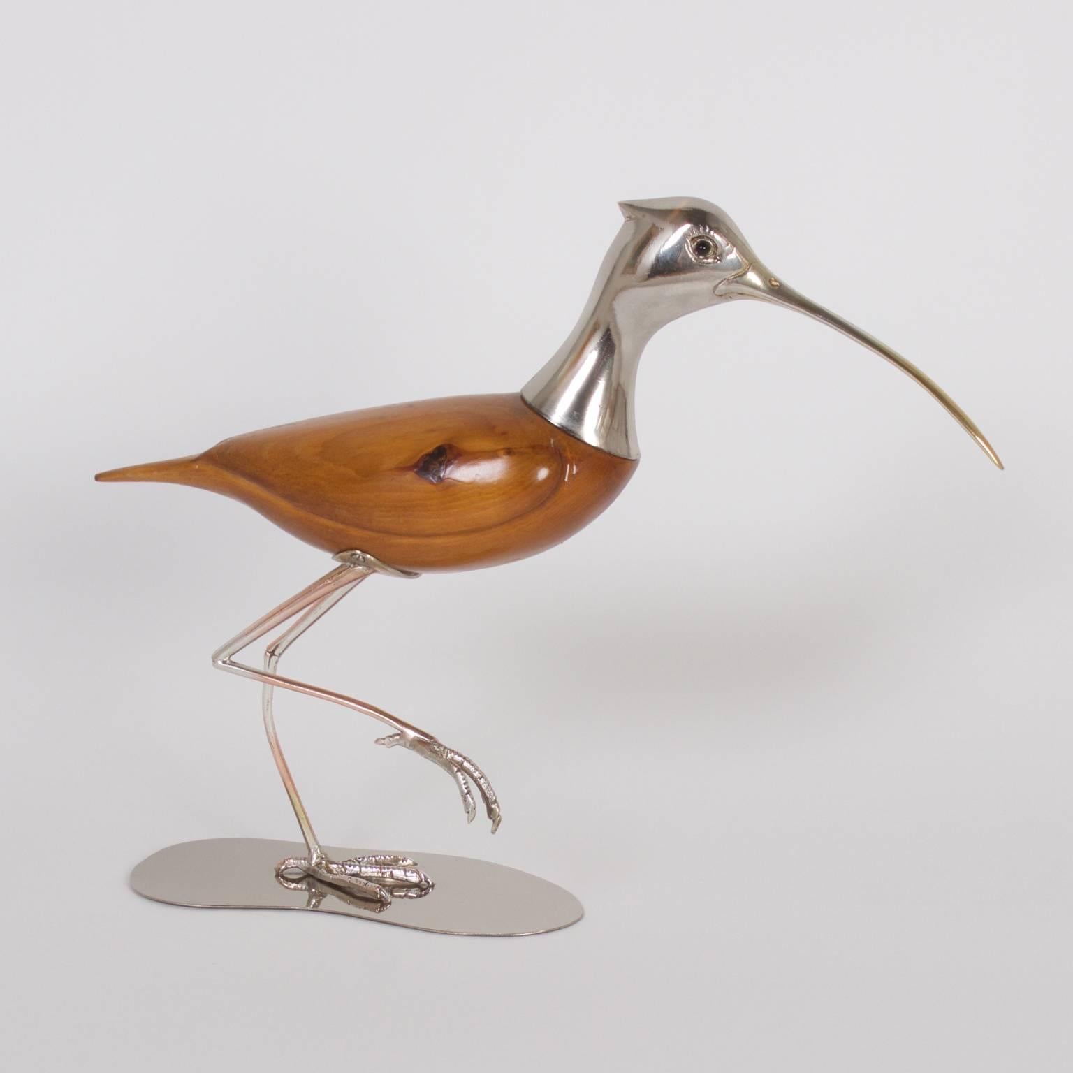 Here are two modern bird sculptures expertly crafted with silvered metal and knotty pine. Both figures display the artist's acute knack for capturing the spirit of the birds in a stylized Mid-Century technique. Both signed DS on the