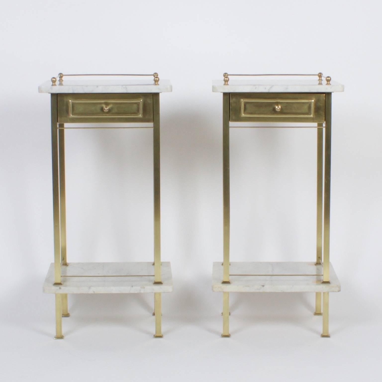 Here is a dapper pair of antique, English nightstands with sturdy brass frames and two white marble tiers both with brass galleries. Featuring a no nonsense form that crosses the style lines between Arts and Crafts, Industrial and modern.