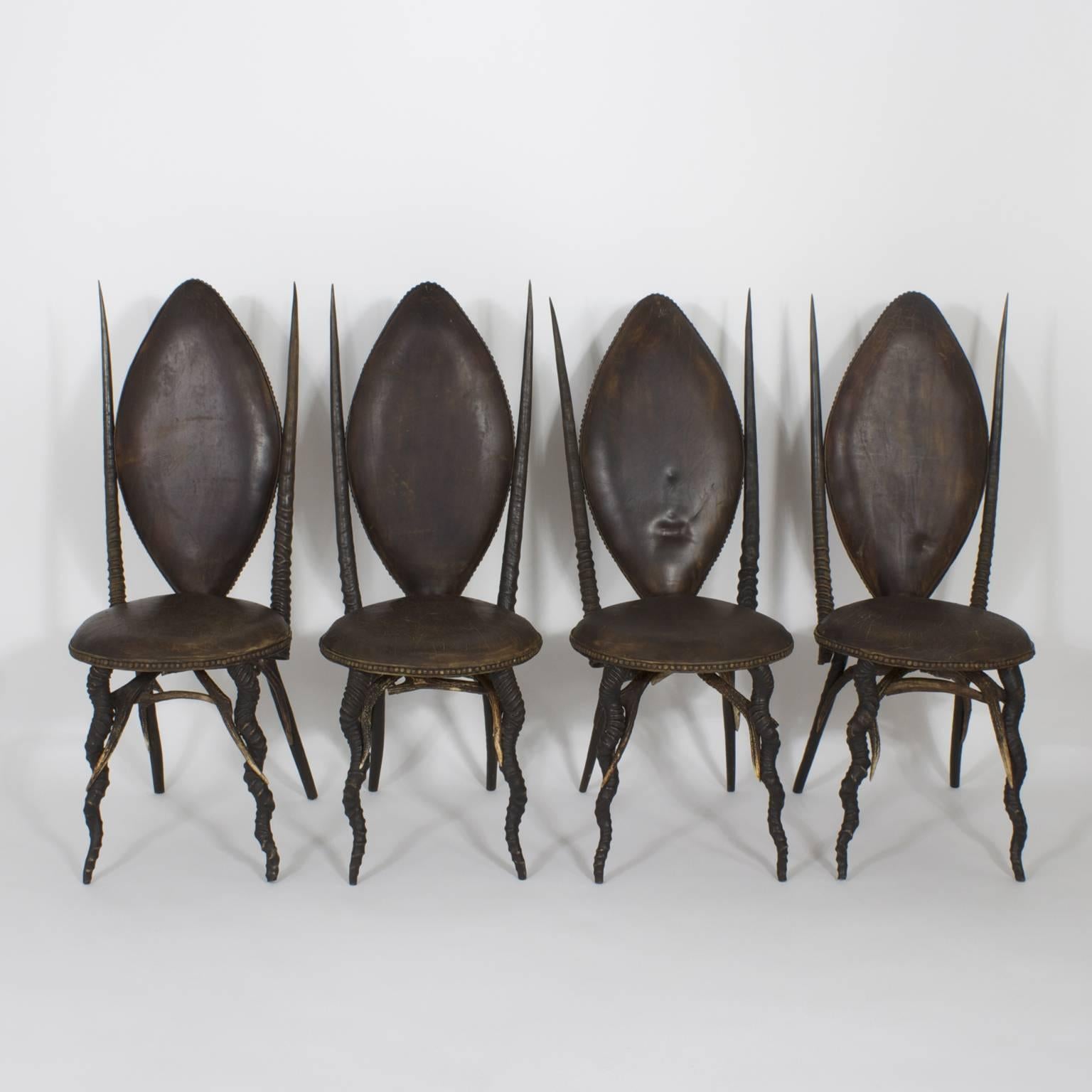 Highly unusual, exotic set of six dining chairs, complete with two arm and four side chairs. Crafted with an unlikely collection of African animal horns including Kudu, Gemsbok, and Ibex. Possibly assembled in Northern Europe where deer antlers were