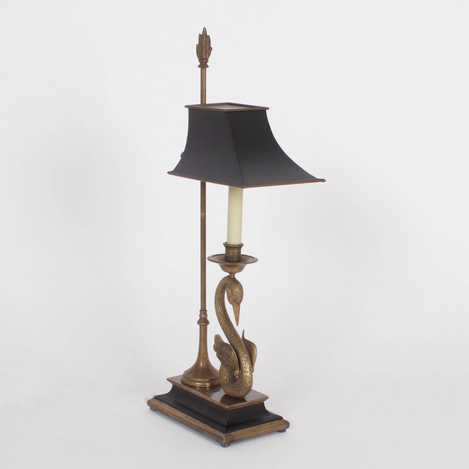 Rare and unusual French bouillotte or desk lamps with adjustable painted metal shades on a brass rod attached to a classical base. These handsome lamps feature cast brass swans with a mythological vibe. Newly wired.