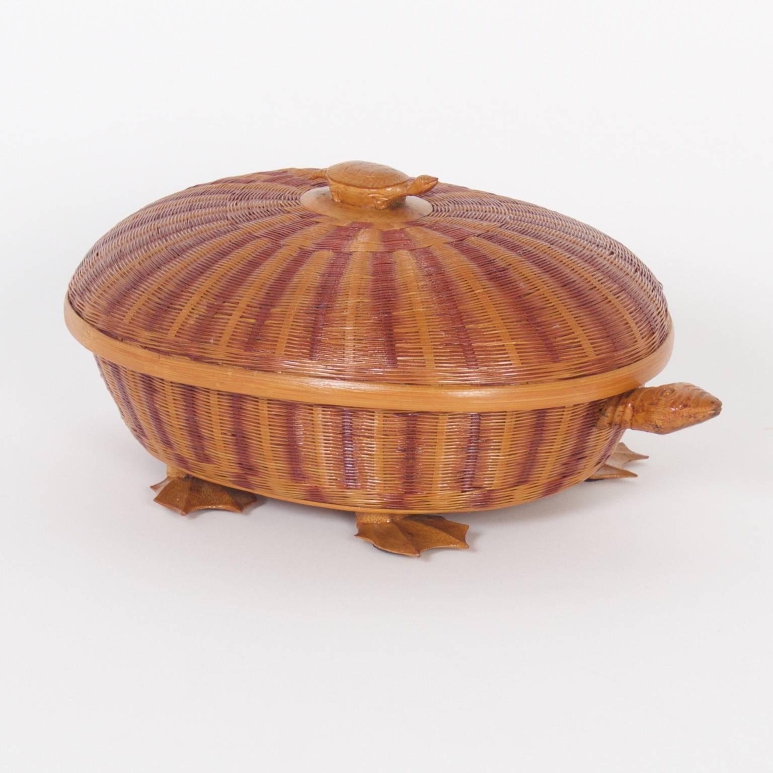 Amusing Mid-Century wicker turtle box crafted with an intricate basket type weave and having a baby turtle as a handle on top. Removing the lid reveals a surprising herring bone pattern in the interior. The head and feet are carved wood.
