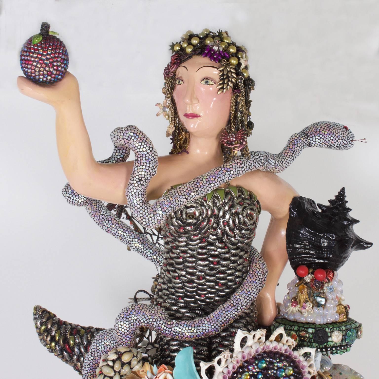 Outrageous larger than life piece of Folk Art painstakingly composed of found objects such as sea shells, beads, toys, vintage jewelry buttons, and bottle caps (to name a few). There is an obvious reference to Eve and snake, that the artist seems to