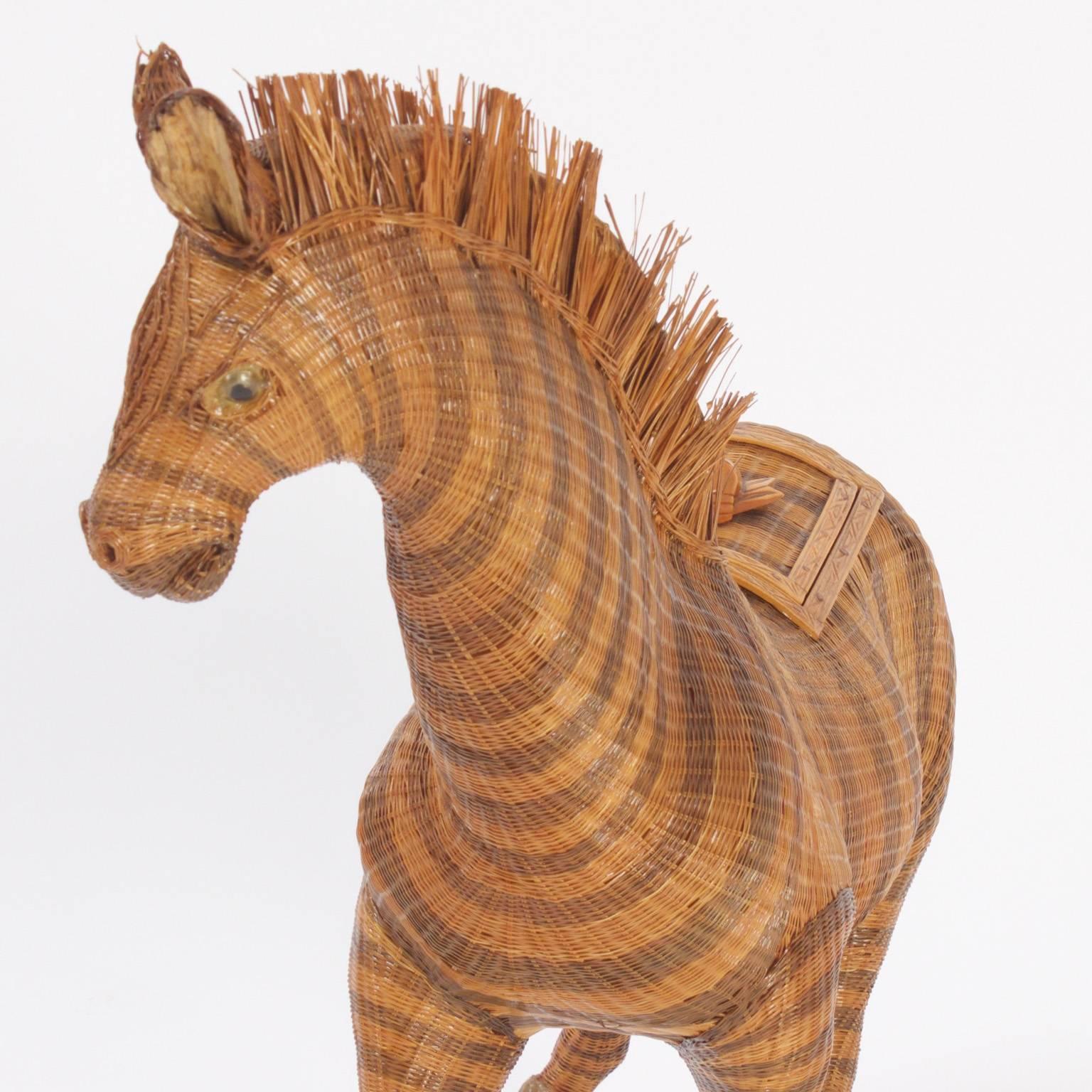 Charming wicker zebra with an intricate woven construction and life like posture. This zebra functions as a basket or box, having a latch on the back with faux a bamboo handle that open to reveal storage compartments.
 
