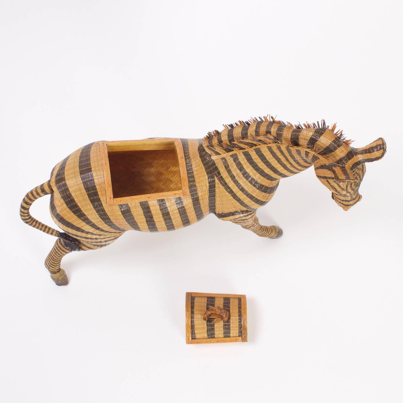 Charming wicker zebra with an intricate woven construction and life like posture. This zebra functions as a basket or box, having a latch on the back with faux a bamboo handle that open to reveal storage compartments. A similar one is available