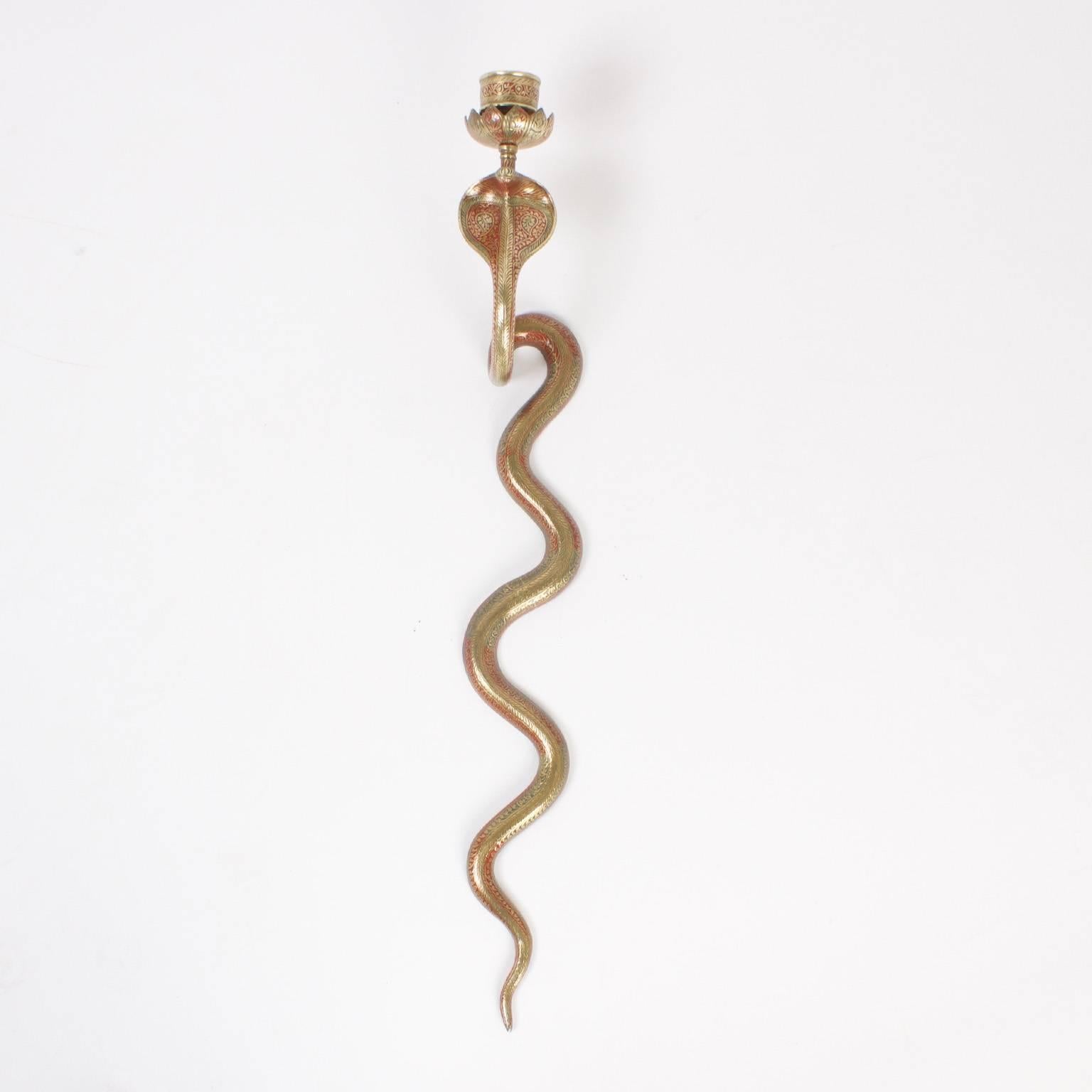 Sleek, Mid-Century cast brass cobra snake sconces crafted with unexpected detail and decorated with red and green paint. 

  