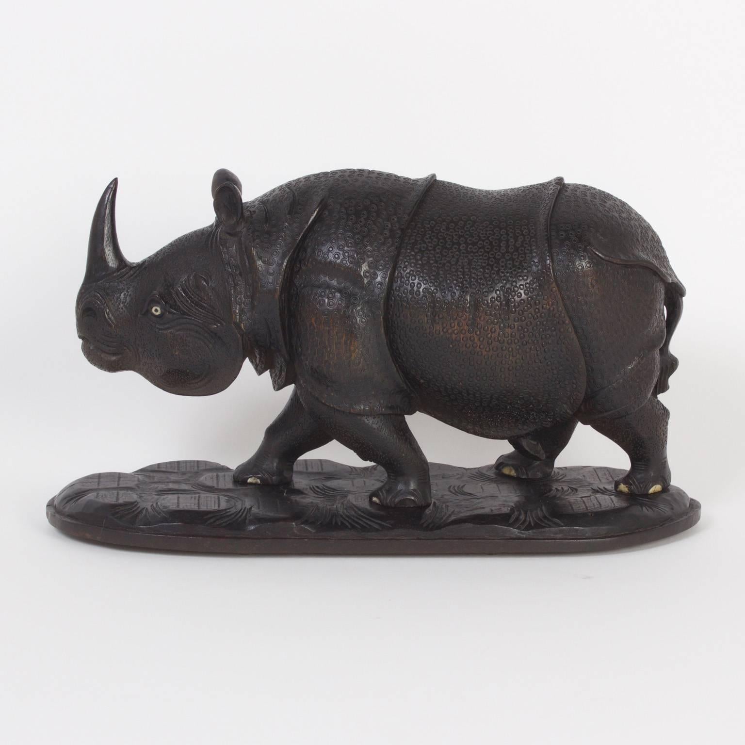 Impressive Anglo Indian rhinoceros expertly carved from a single block of teak. Featuring bone eyes and toes, and an attitude that captures the power and prestige of these magnificent animals.

  