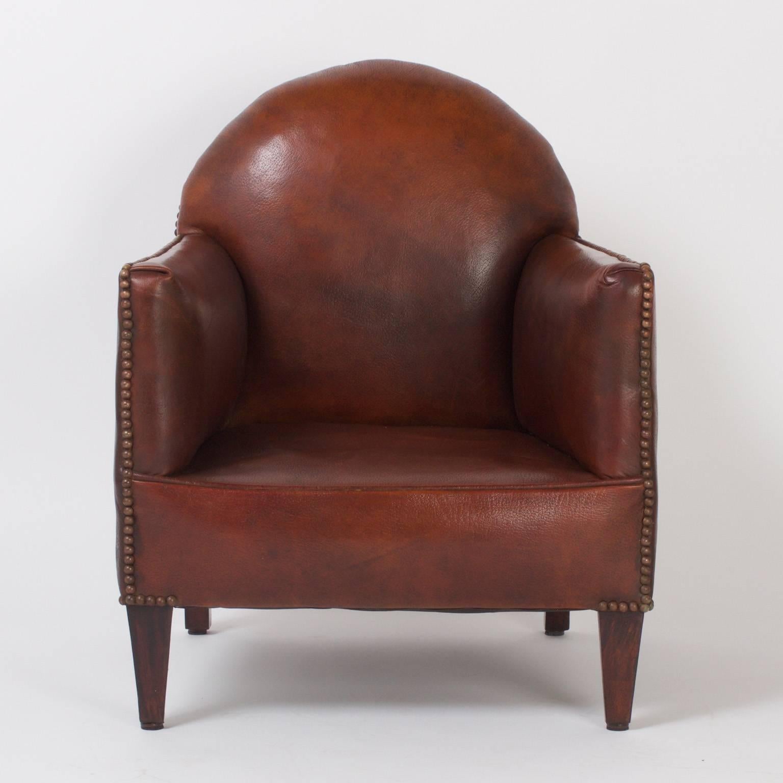 For children with sophisticated taste: A rare pair of French Art Deco child’s armchairs or club chairs upholstered in the original soft brown leather. The diminutive, yet Classic form is highlighted by brass studs. The front legs are tapered and the