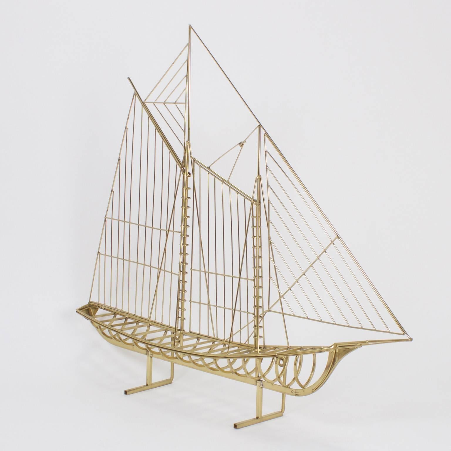 As if it were a three dimensional drawing, this mid century modern brass plated sail boat sculpture has bold decorative appeal. Can be displayed on a flat surface or mounted to a wall. Signed C. Jere 1976.
