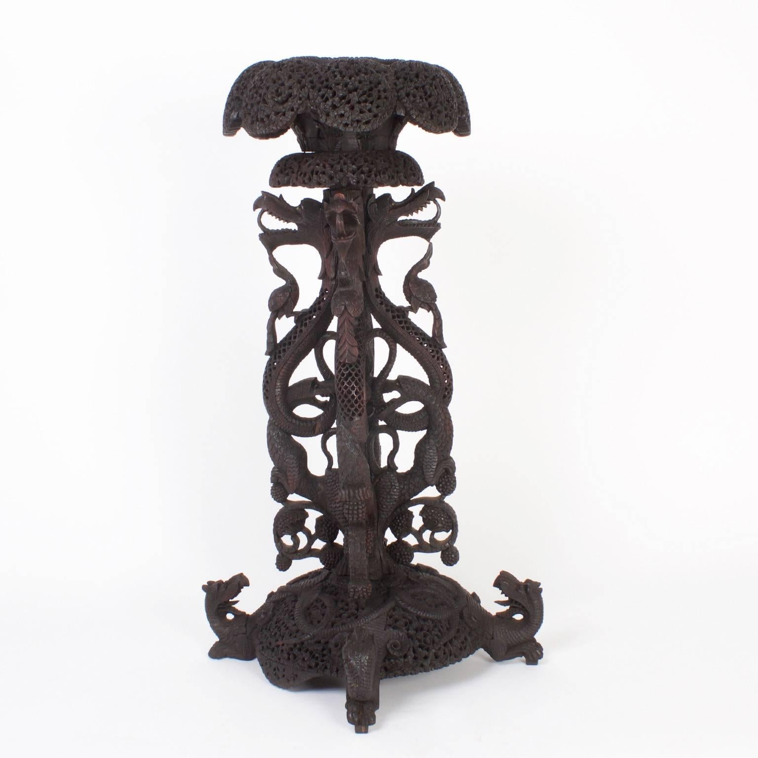 Intriguing Anglo-Indian pedestal expertly carved from tropical hard wood and transformed into this mythological composition with flowers, dragons, phoenix birds, eagles, swans, snakes, and fruit. The best of this genre we have seen.
