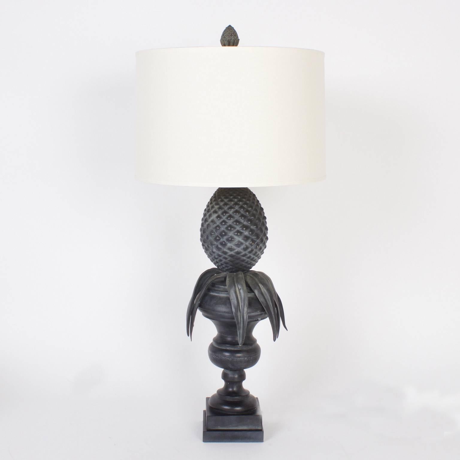 Long a symbol of hospitality, the pineapple has been used in the decorative arts in many forms. These chic modern composition table lamps have a faux aged lead patina that brings this classical idea to the Mid-Century with aplomb.