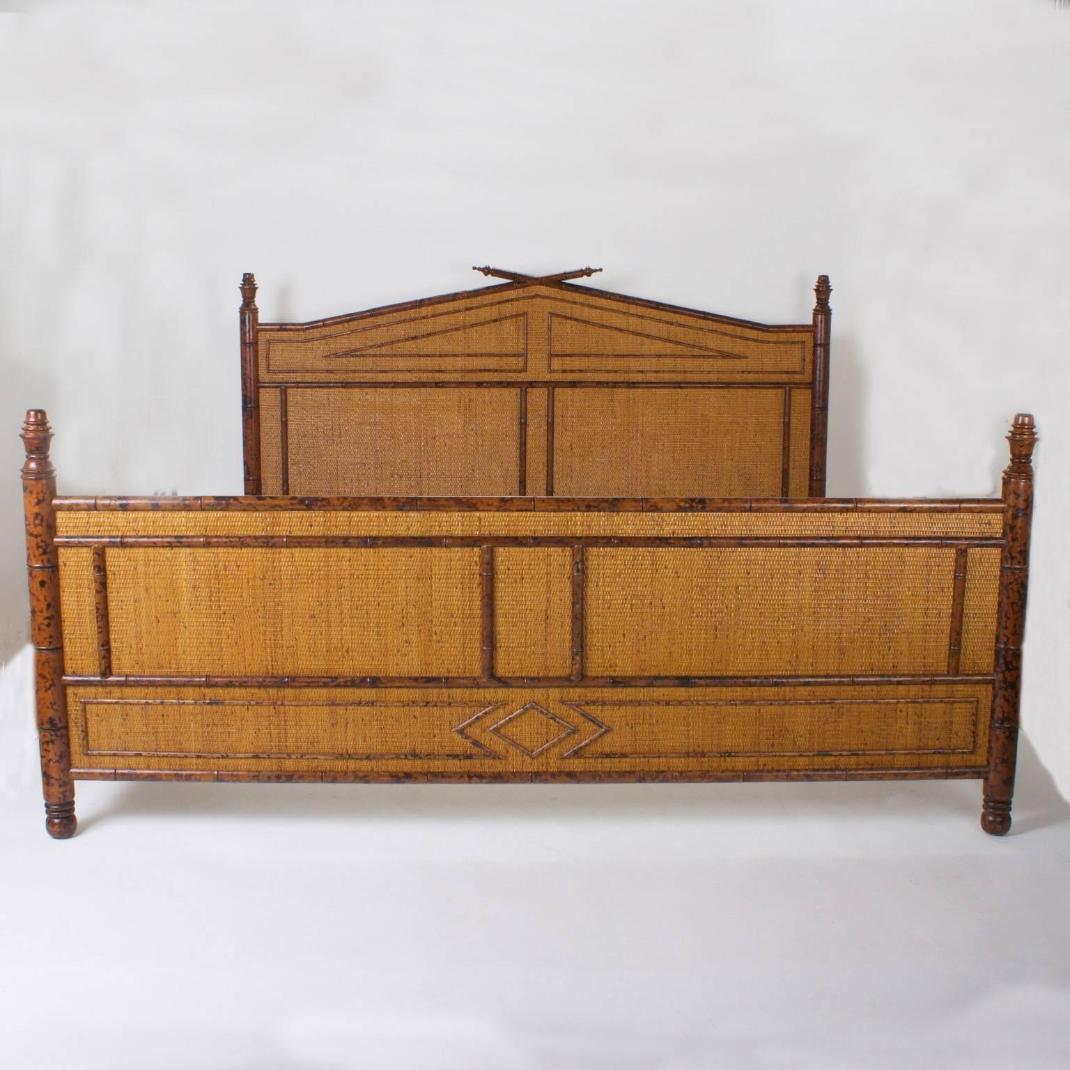Mid-Century California or super king-size bed that includes headboard, footboard, and side rails. Featuring faux bamboo posts with turned finials and feet and geometric designs over grass cloth panels. This bed packs plenty of decorative punch with