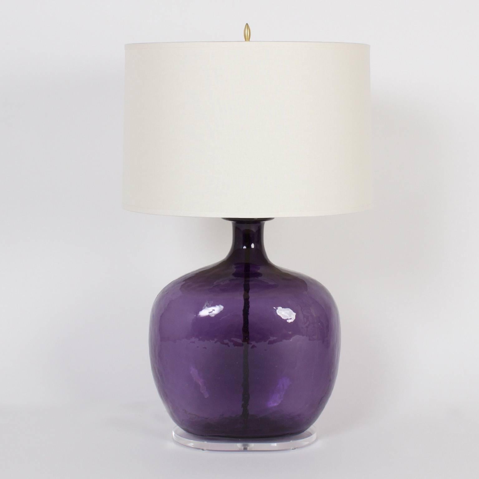 Exclusive pair of table lamps made from bulbous purple glass jars that where begging to be turned into lamps. Finished with a custom Lucite base.

 