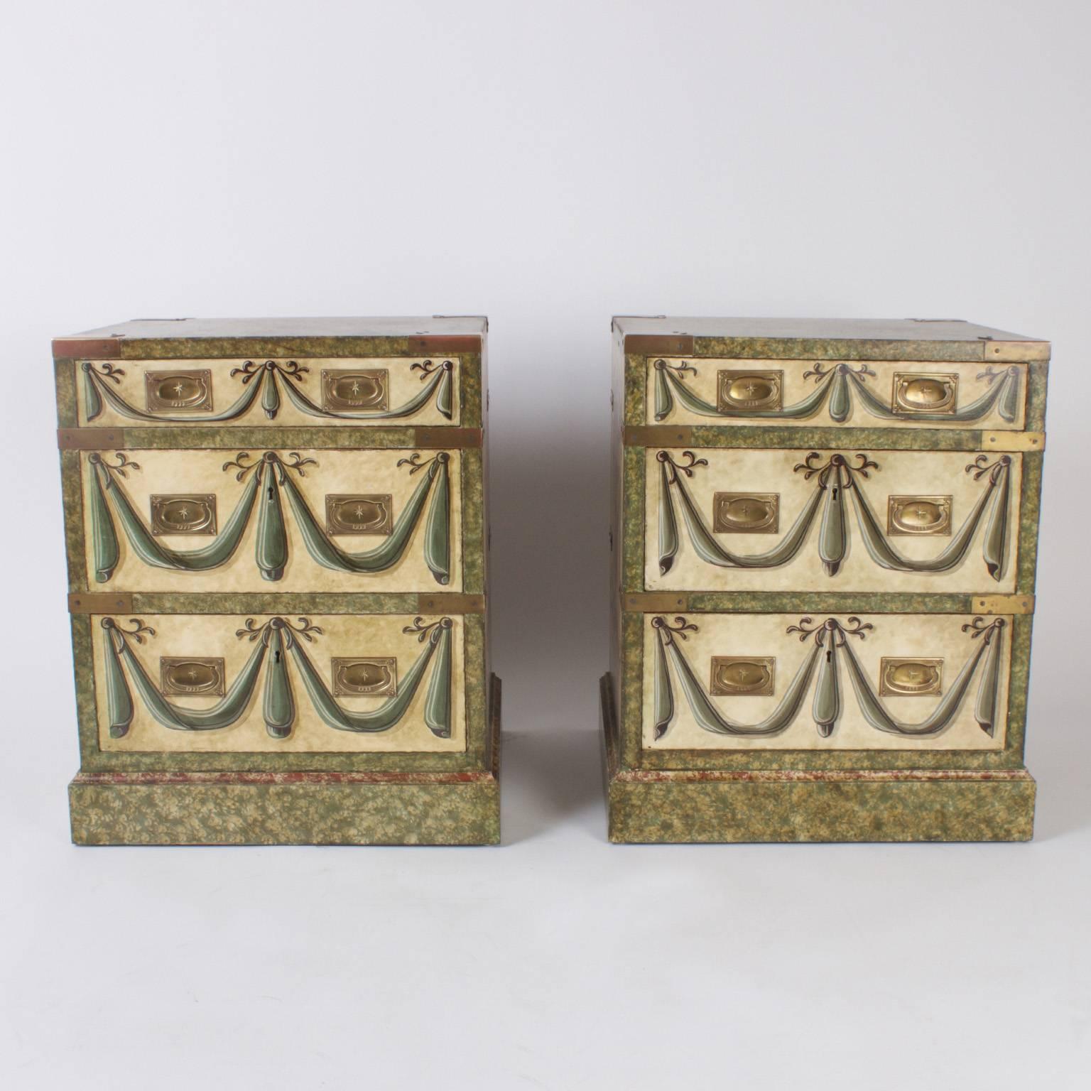 Pair of vintage three-drawer Campaign style nightstands or chests with trompe l'oeil style hand painting swags, curtains and flowers. The form and hardware suggest Campaign, yet the overall ambiance is theatrical.
 