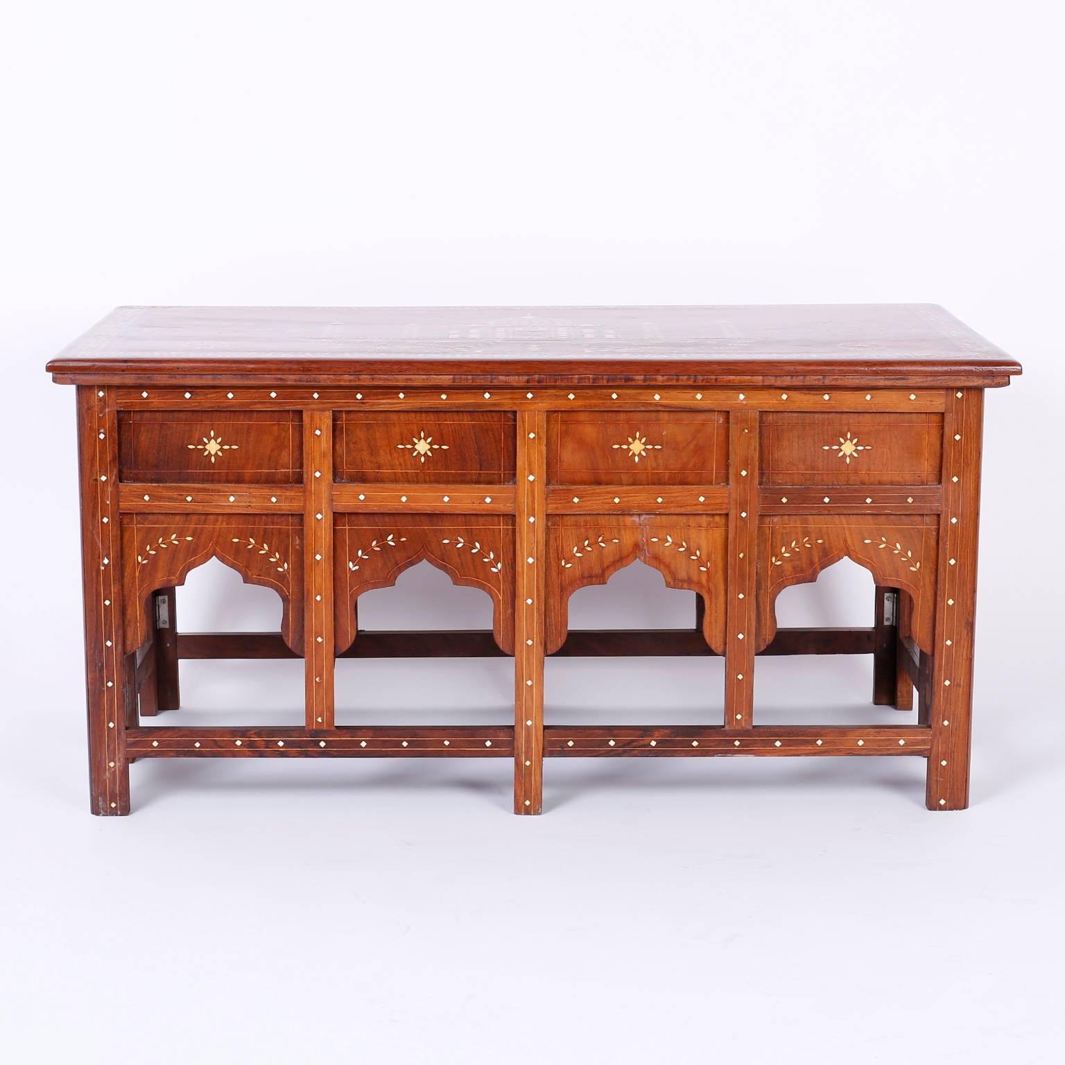 Antique Anglo Indian Mahogany low table or coffee or cocktail table featuring expertly crafted bone inlays of the Taj Mahal, phoenix birds, floral and geometric boarders, flowers and a fountain complete with jumping fish. The folding table base uses