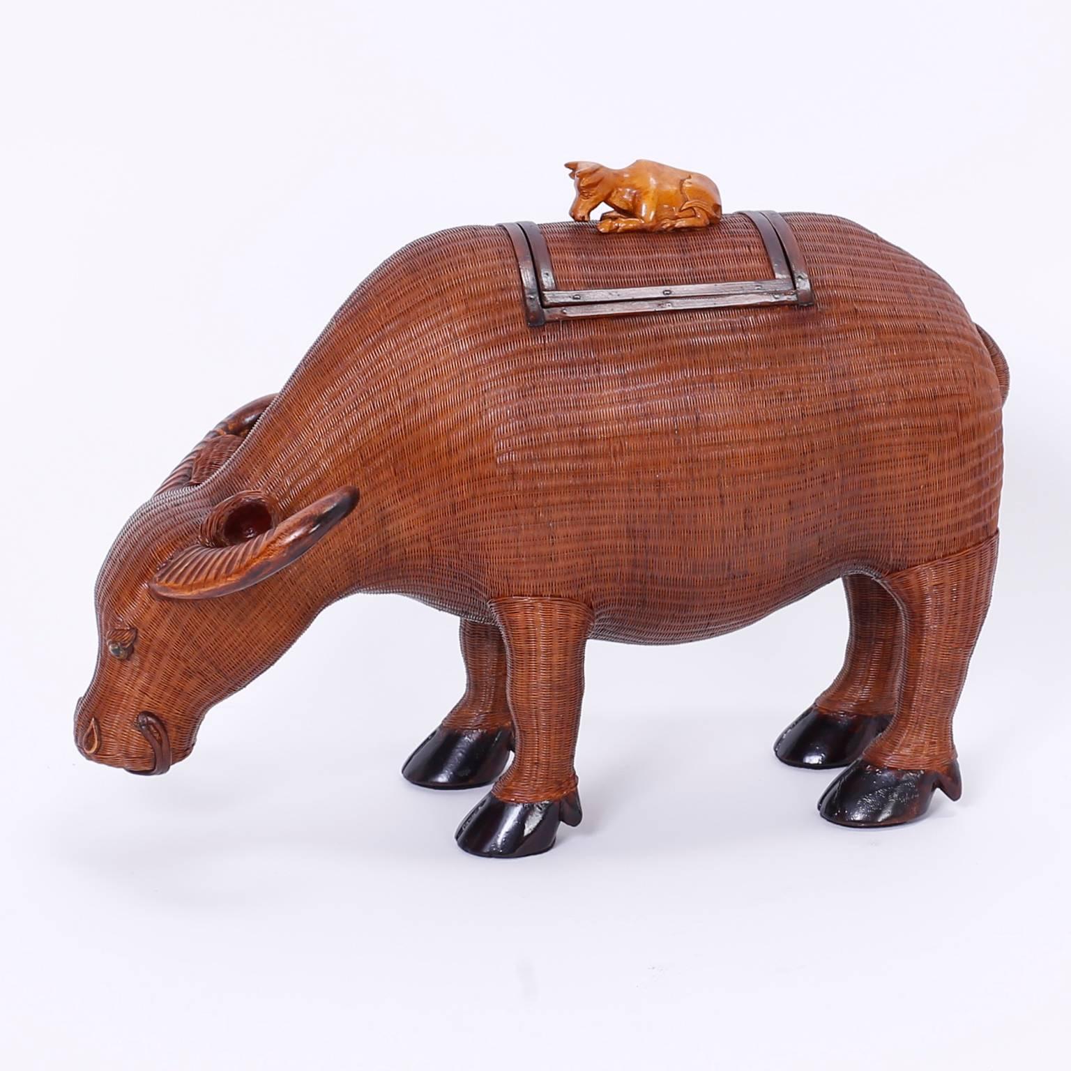 From the Shanghai collection of traditional Chinese works of art; a wicker ox. Crafted with an impressive attention to detail with wicker and wood and having a young ox as a handle to the removable lid. 

