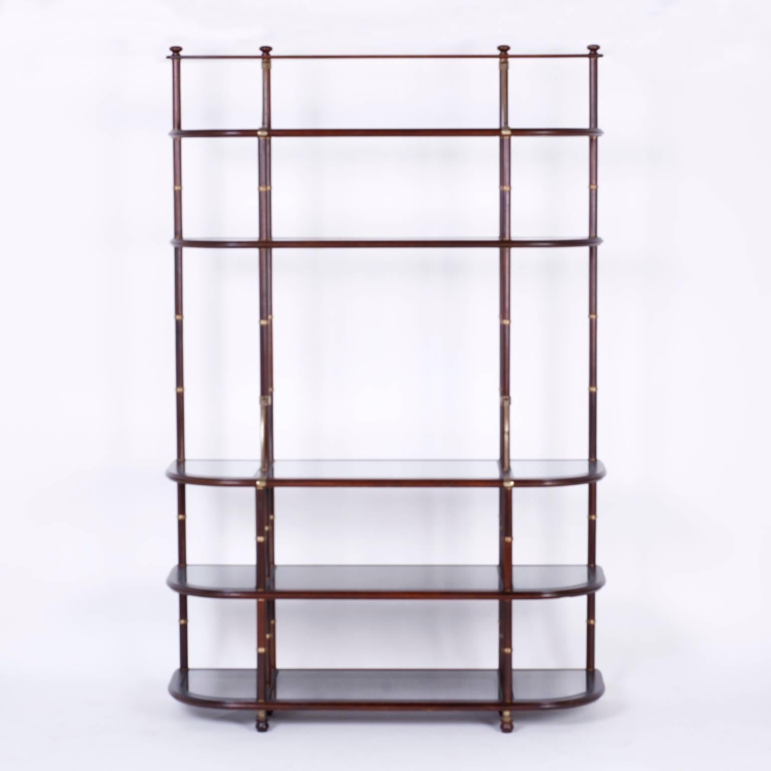 Tall, sophisticated mahogany étagère or shelf with an interesting mixture of influences and materials. The brass cuffs suggest an elegant Regency faux bamboo style while the tone of the mahogany, the brass supports and caned lower three shelves have