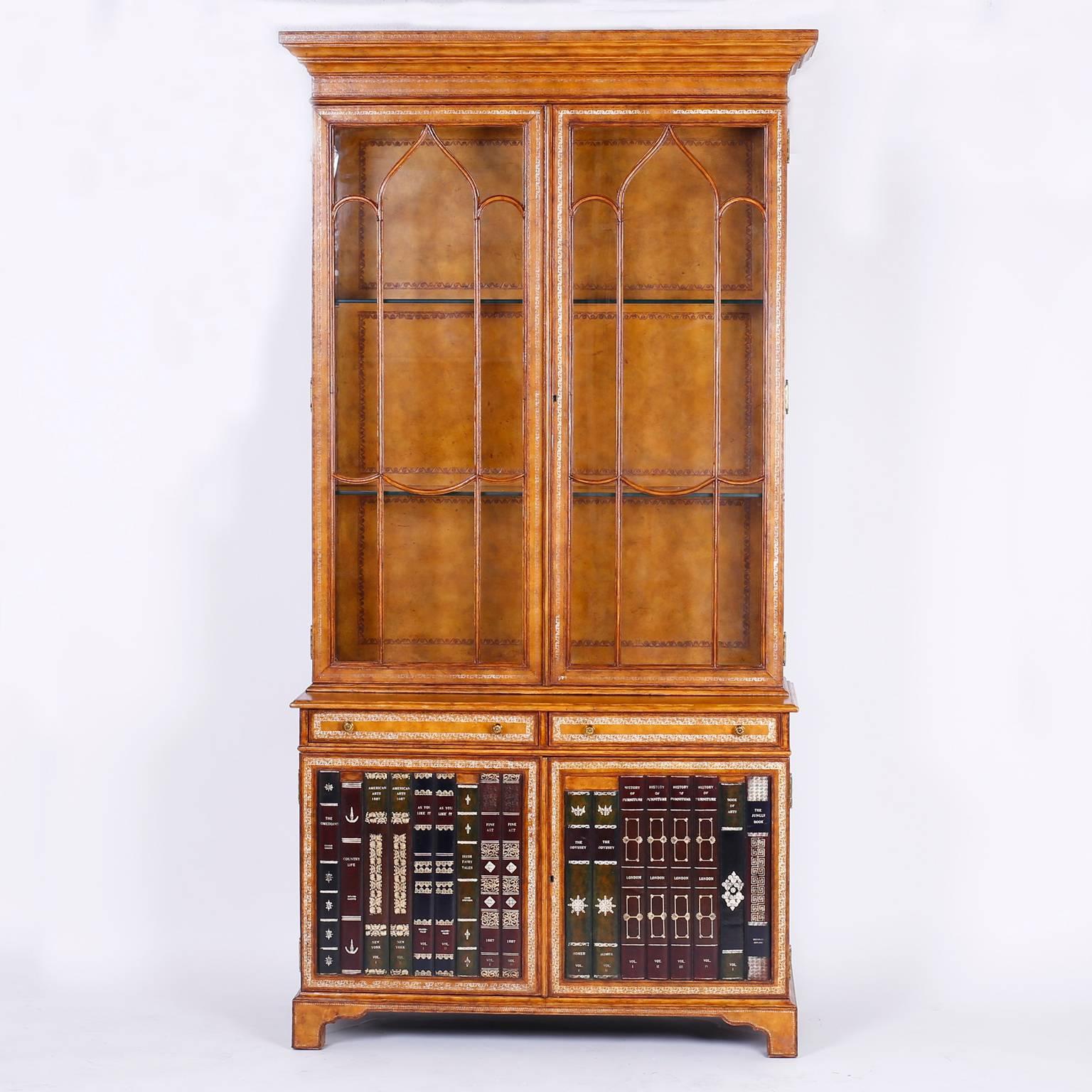 Tall, stately, and serious cabinet or bookcase entirely clan in tooled tan leather. Having two glass lockable doors in the top case and featuring faux leather books on the lower case doors. Signed Maitland-Smith in a drawer lined with marbleized