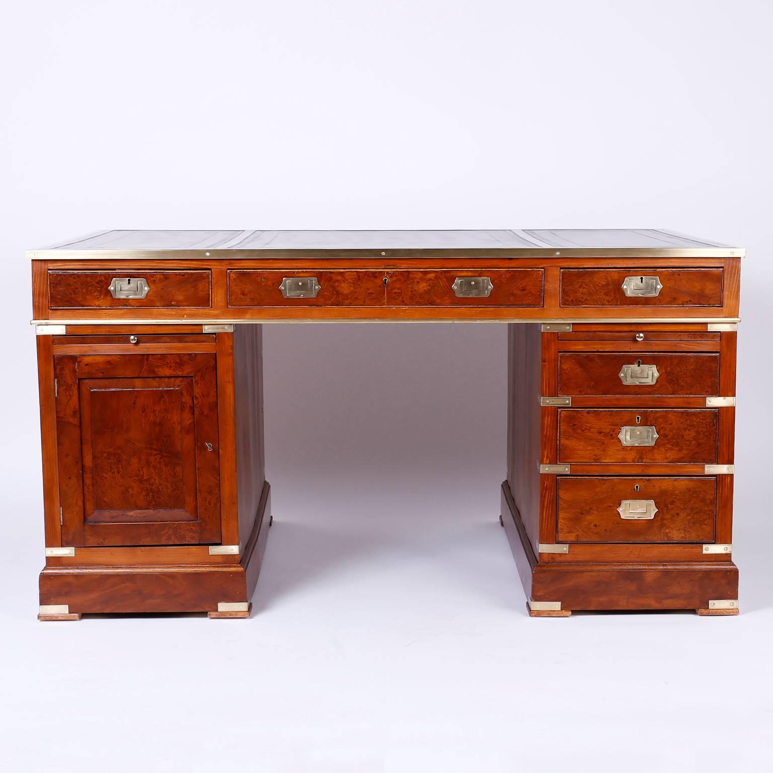 Stand out 19th century mahogany three-piece partners desk with three brown tooled leather panels on top. The top case has three drawers on either side and outlined with brass. The pedestals have three drawers on one side and a cabinet door on the