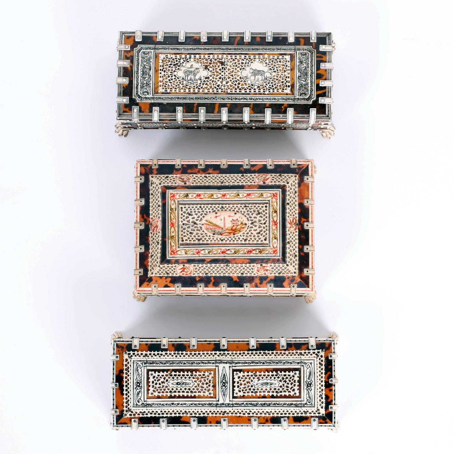 Here are three rare antique Anglo Indian boxes crafted with traditional materials each with a tortoise shell background than overlaid intricate, engraved bone work. All three boxes are set on carved cat feet. Priced individually. 

Ref: 1478 and
