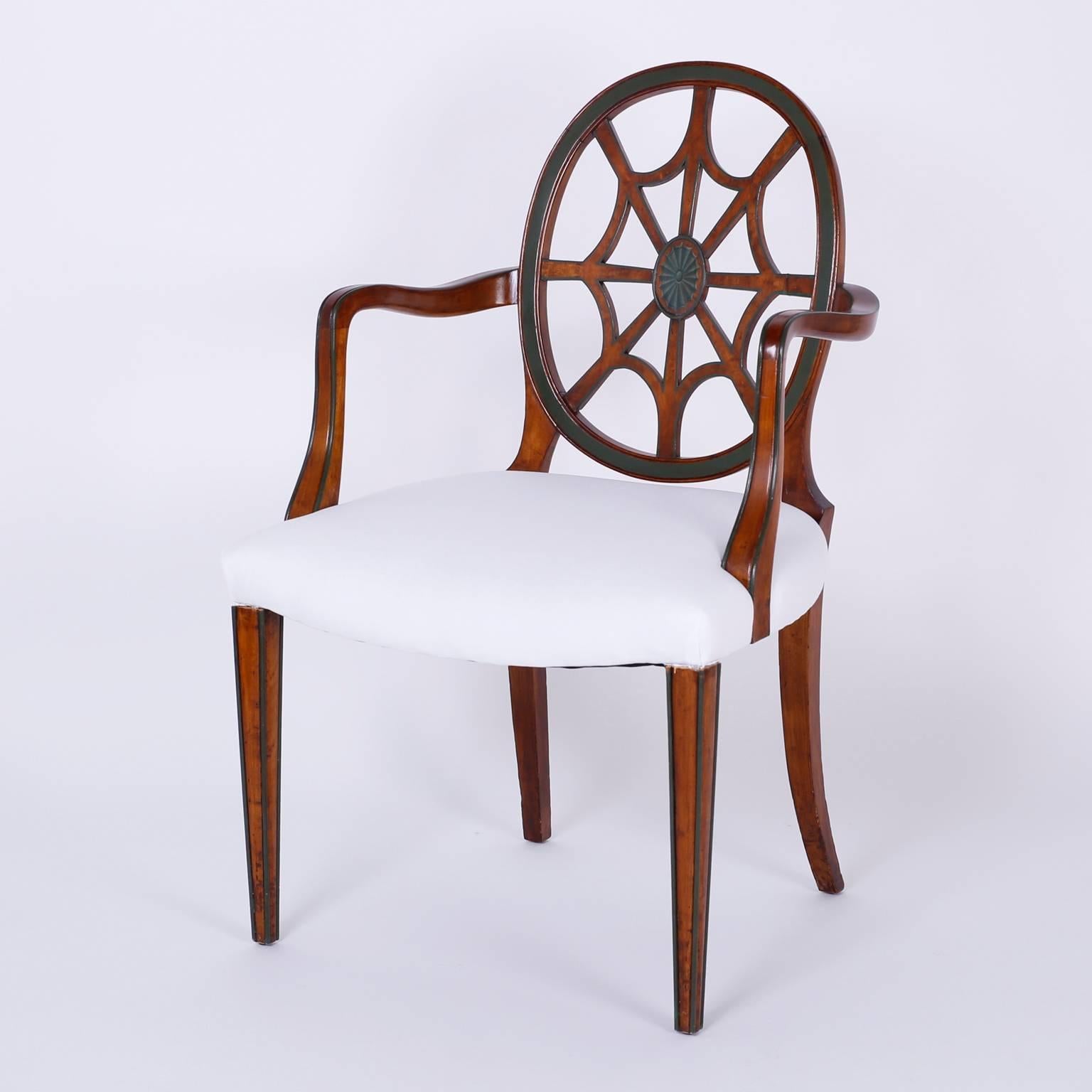 Here is a rare set of 12 dining chairs, two arm and ten sides. Expertly crafted from mahogany in the neoclassic Adam Style with unusual spider web backs. The painted decorations are typical of the period and well represented here. 

Armchair
