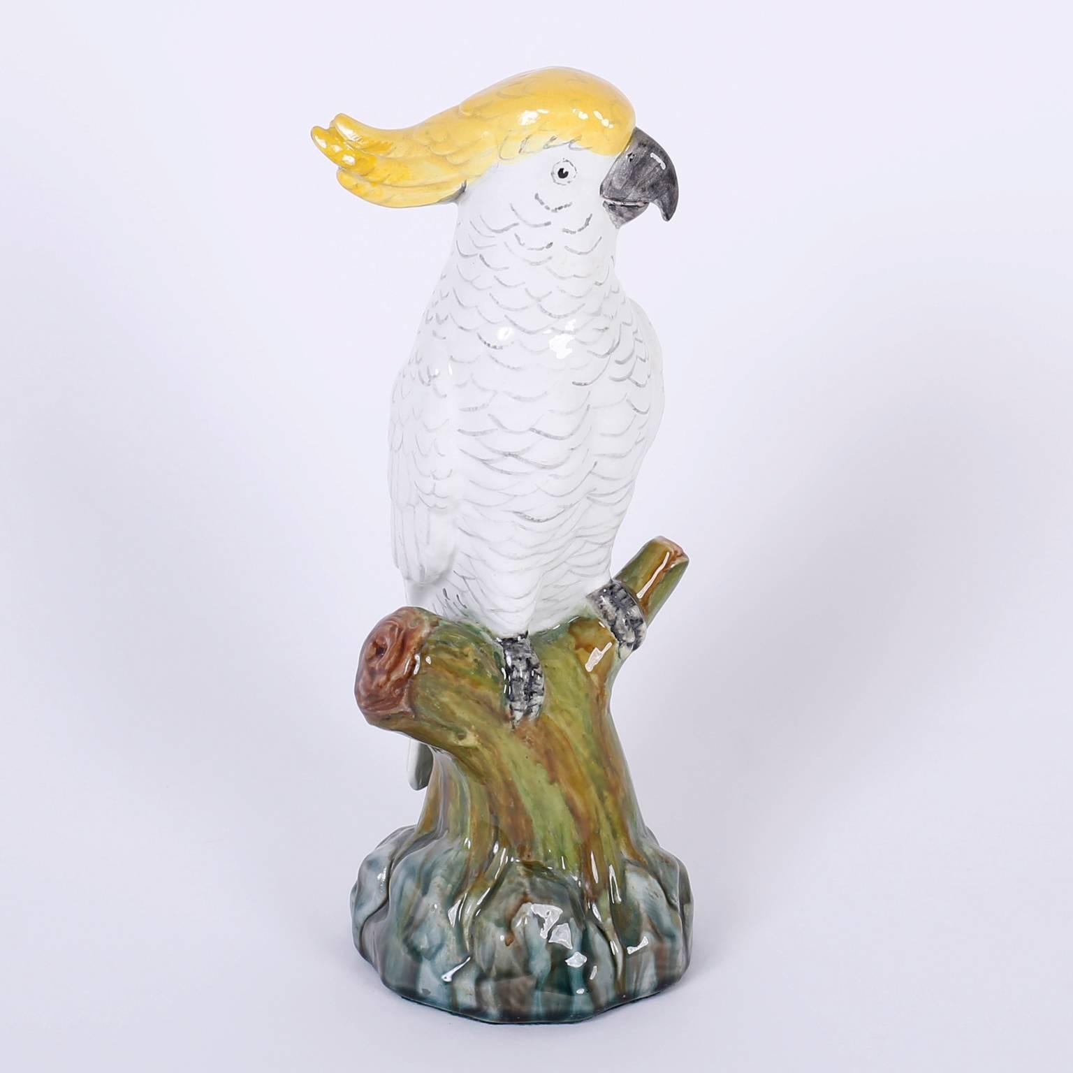 Amusing, decorated and glazed terra cotta parrots or cockatoos who seem rather comfortable with each other, both perched on a tree trunk signed on the underside Mintons England.

Left bird measures H 12.5 x W 4.5 x D 4.5
Right bird measures H