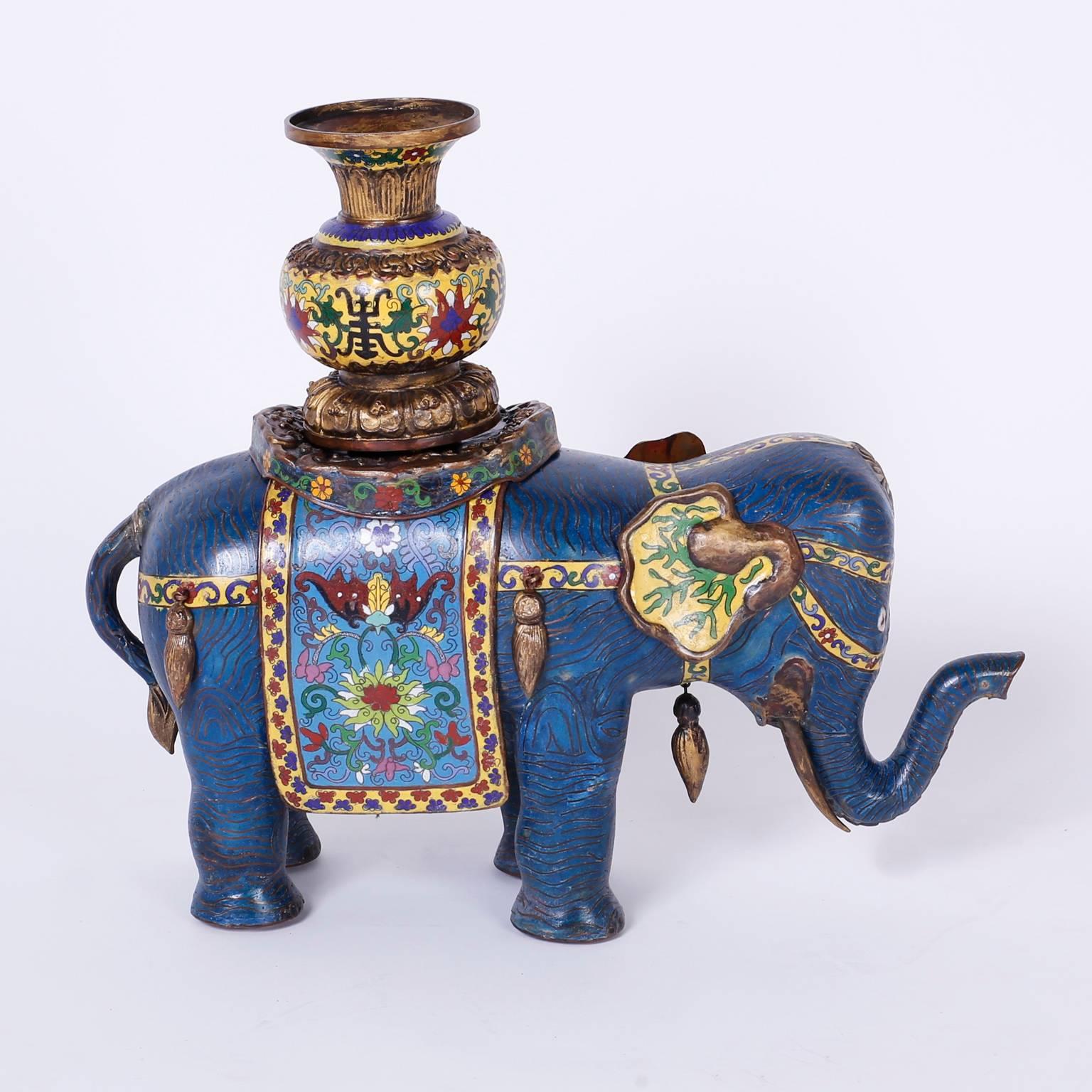 Highly unusual and decorative pair of vintage cloisonné elephants, decorated with floral and geometric enamel designs that can be enjoyed for what they are, or can be used as planters. The removable vessels or urns can hold orchid moss, the bodies