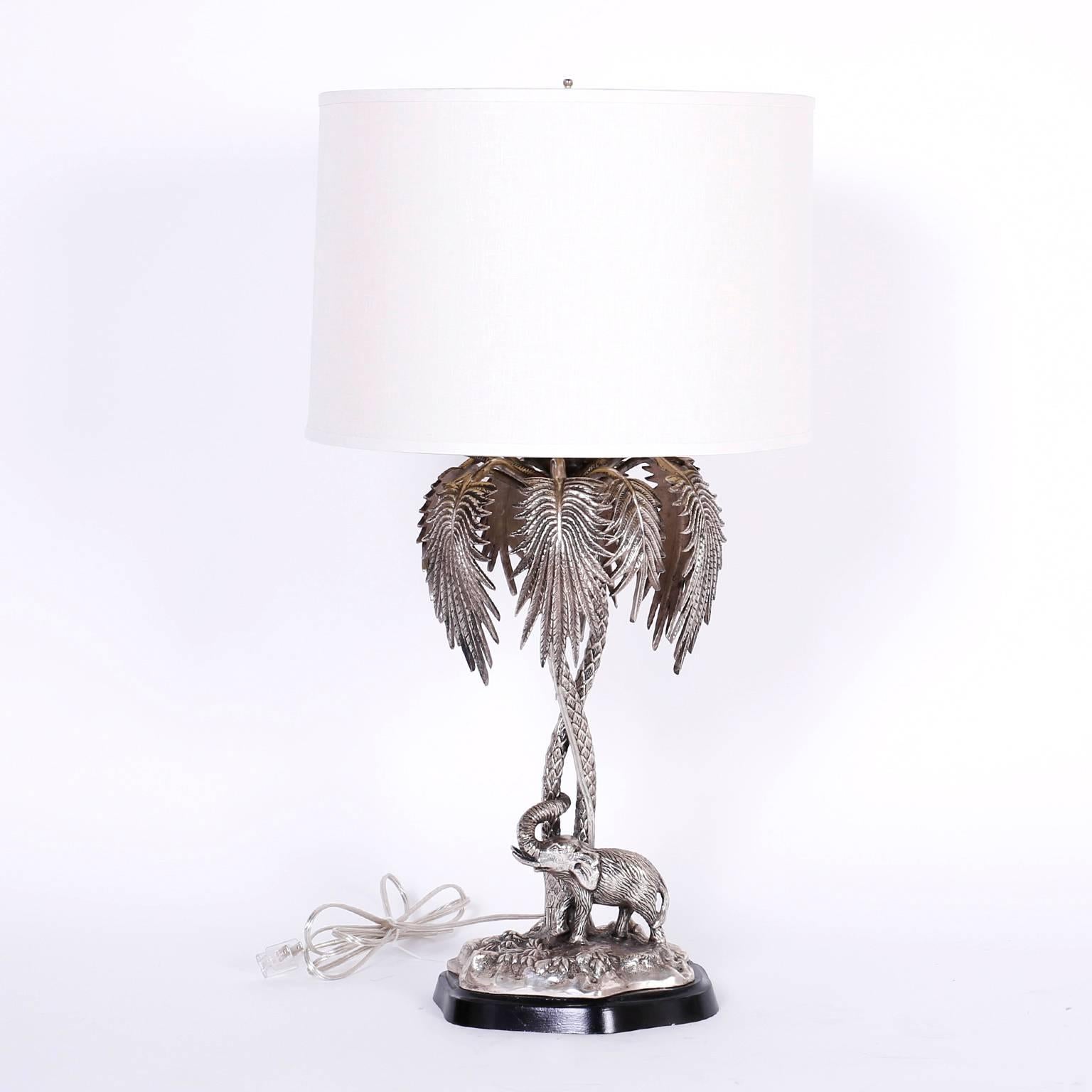 Transporting pair of silvered metal English epergnes converted to table lamps depicting an elephant and a camel both on a patch of terra firma under two intertwined palm trees. Newly wired.