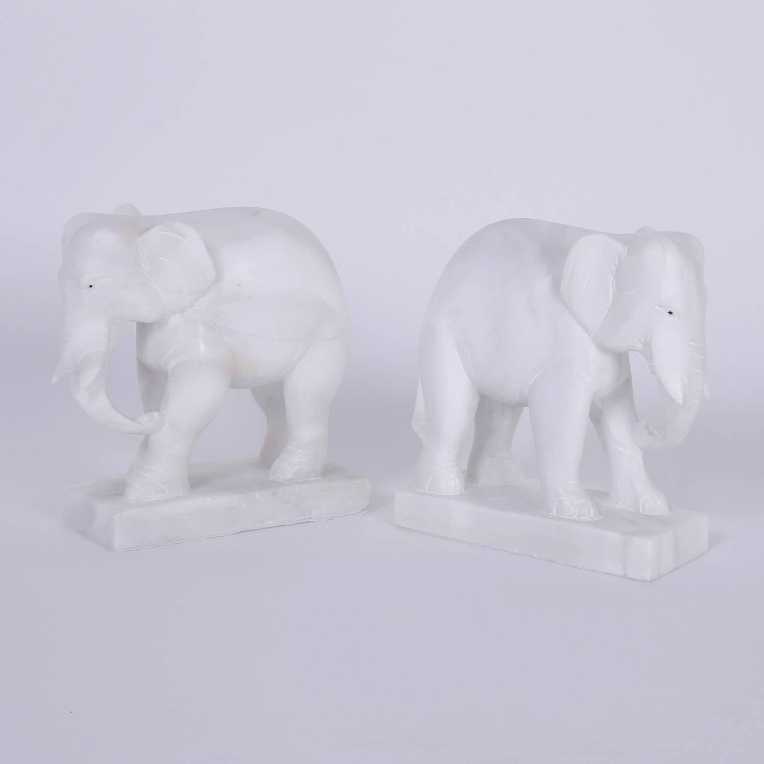 You can enjoy this pair of British Colonial alabaster elephants as bookends or just appreciate them as objects of art. Hand-carved from blocks of stone and ready to stand for decades.