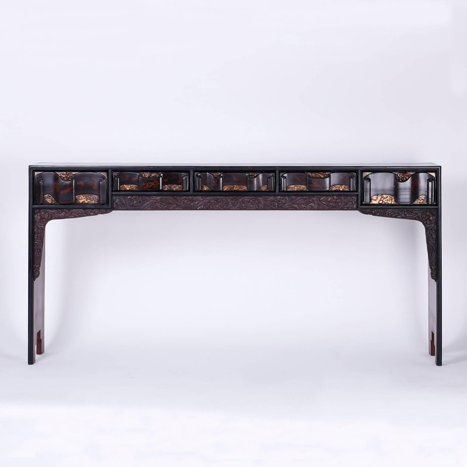 Inspired Chinese console with an unusual mixture of techniques and materials. Featuring five drawers with carved scroll fronts decorated with chinoiserie style paintings of grasshoppers and flowers above carved floral brackets. The top and sides