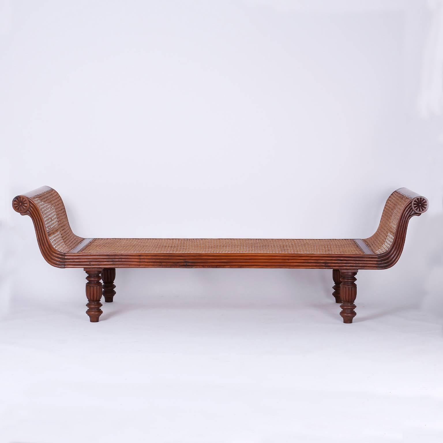 British Colonial, West Indies style daybed, chaise, or backless sofa crafted with indigenous exotic hard woods with a graceful flowing form. Hand caned from head to foot for tropical comfort and supported by four Classic turned and beaded legs.