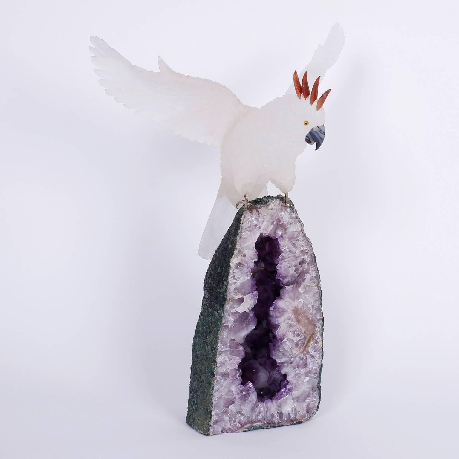 Carved stone cockatoo sculpture caught in the action of landing on an amethyst geode. Featuring a lofty combination of colors and textures with an unlikely life-like attention to detail.