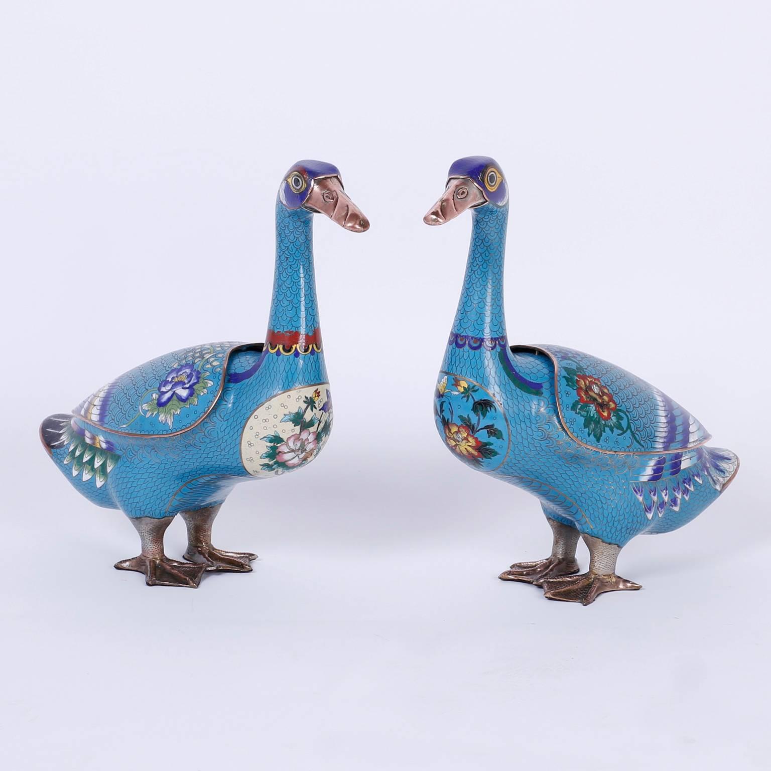 Pair of cloisonné or enamel on copper duck censors or incense burners decorated with charming panels of fauna and flora over a soothing blue background. The wings are removable lids. Can be used for storage, function or enjoyed as objects of art.