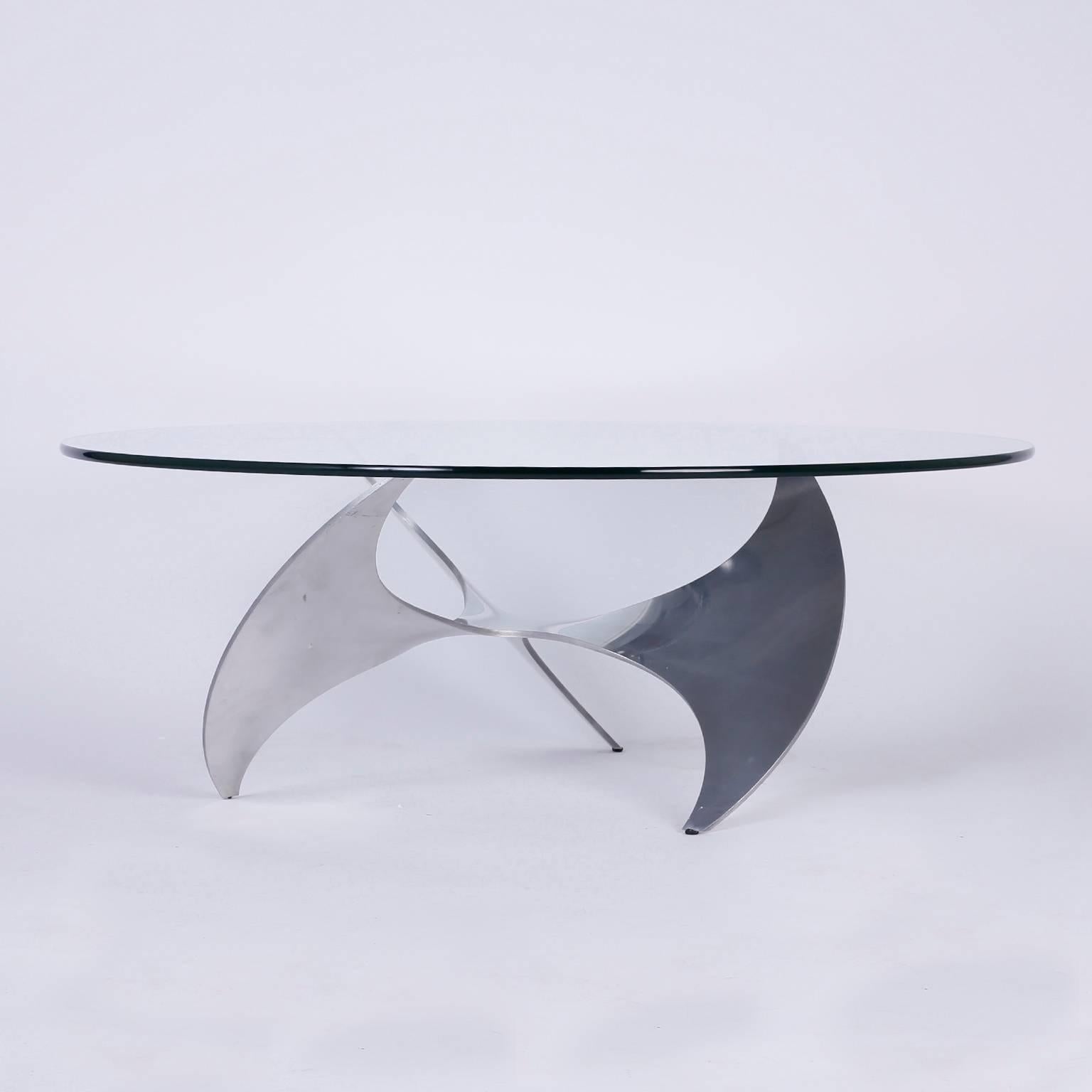 Iconic Propeller shaped coffee or cocktail table by Knut Hesterberg with a round glass top and a cast aluminum base. Perfect combination of Industrial and vogue design.