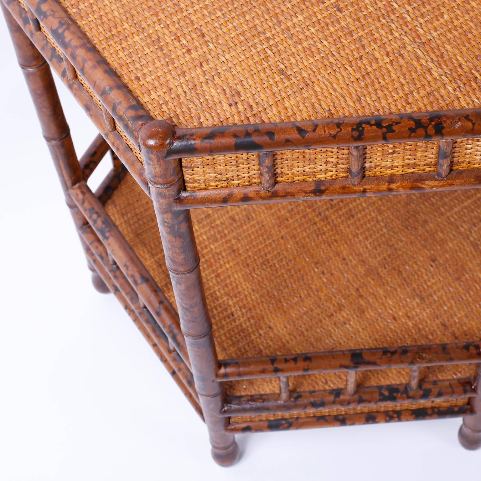 Midcentury faux bamboo and grass cloth two-tiered hexagon occasional table with a soothing organic palette, casual elegance and dynamic function.