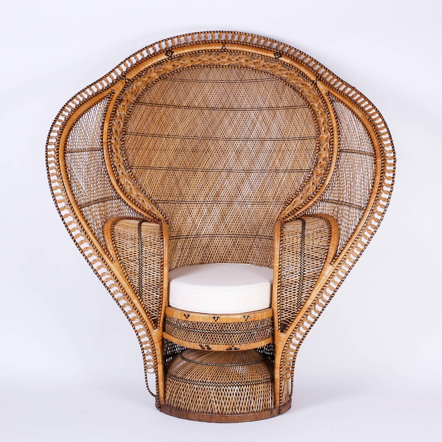 Pair of peacock chairs or cobra chairs with an unusual, dramatic form reminiscent of a cobra. Constructed with rattan, woven for strength and style in an ambitious combination of designs that make these chairs best of the genre.

Seat height