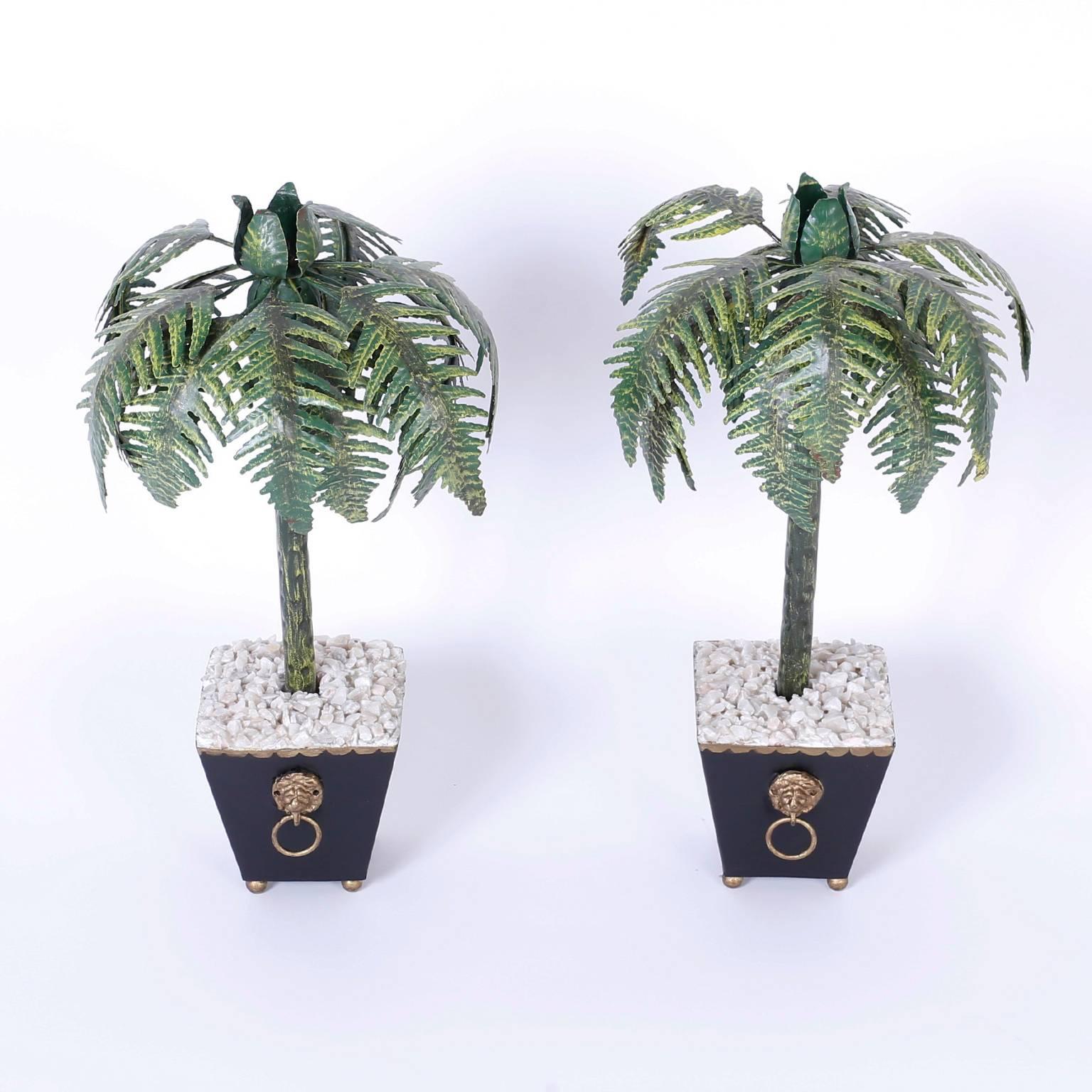 Pair of tole Palm Tree candlesticks set in classical planter style bases with lion head ring handles, white stones, and ball feet. A rare large size for this form.