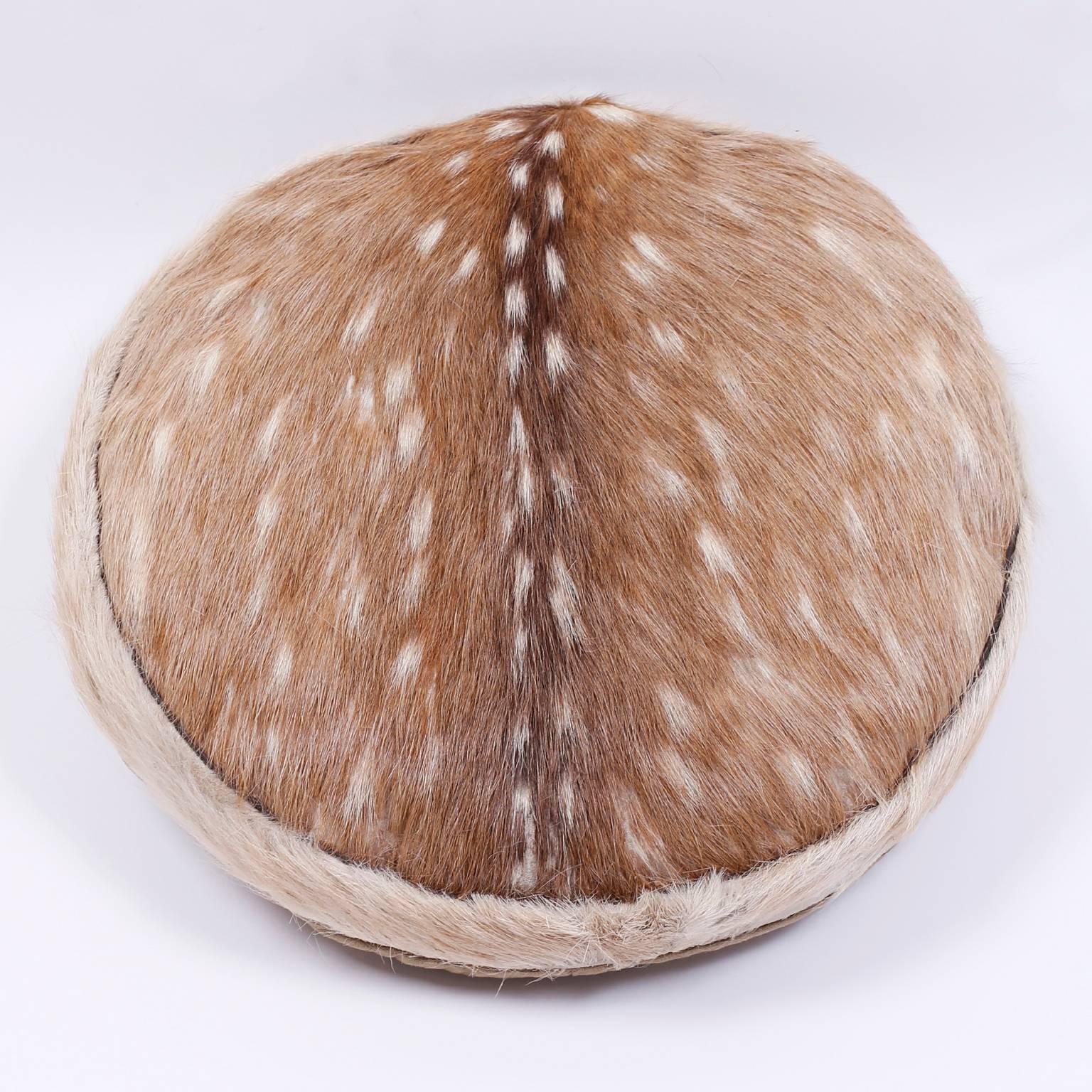 Round handmade pillow crafted from the distinctive spotted chital or axis deer with a two button cotton back.