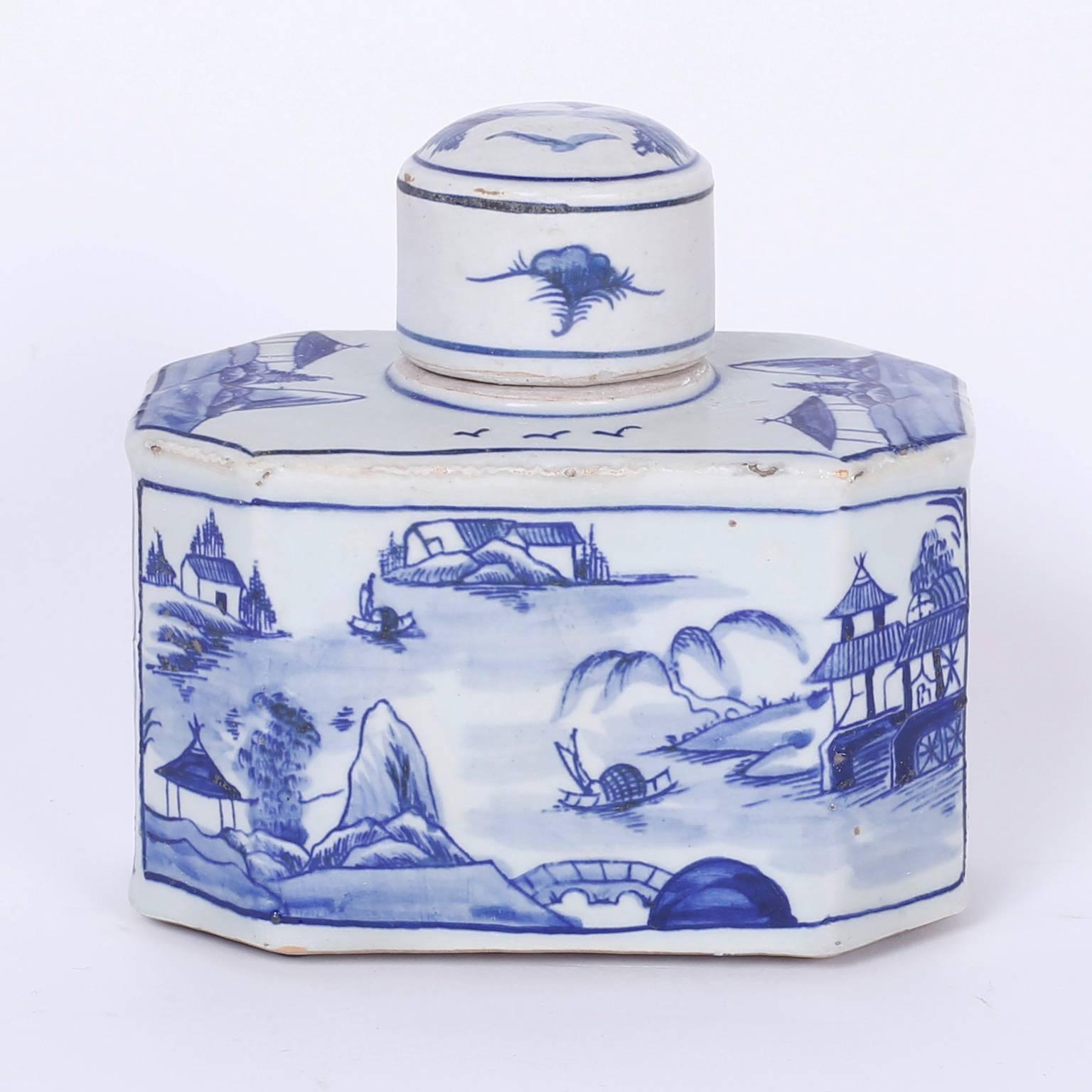 Pair of blue and white Chinese porcelain tea containers with an unusual geometric form and hand decorated water way scenes with boats, bridges, and architecture, in the Canton manner.