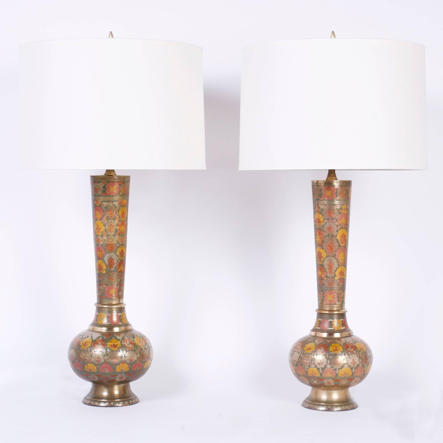 Pair of table lamps crafted with spun and engraved brass in a vogue, modern style and decorated with floral enamel designs. On the Kashmiri style. Newly wired.