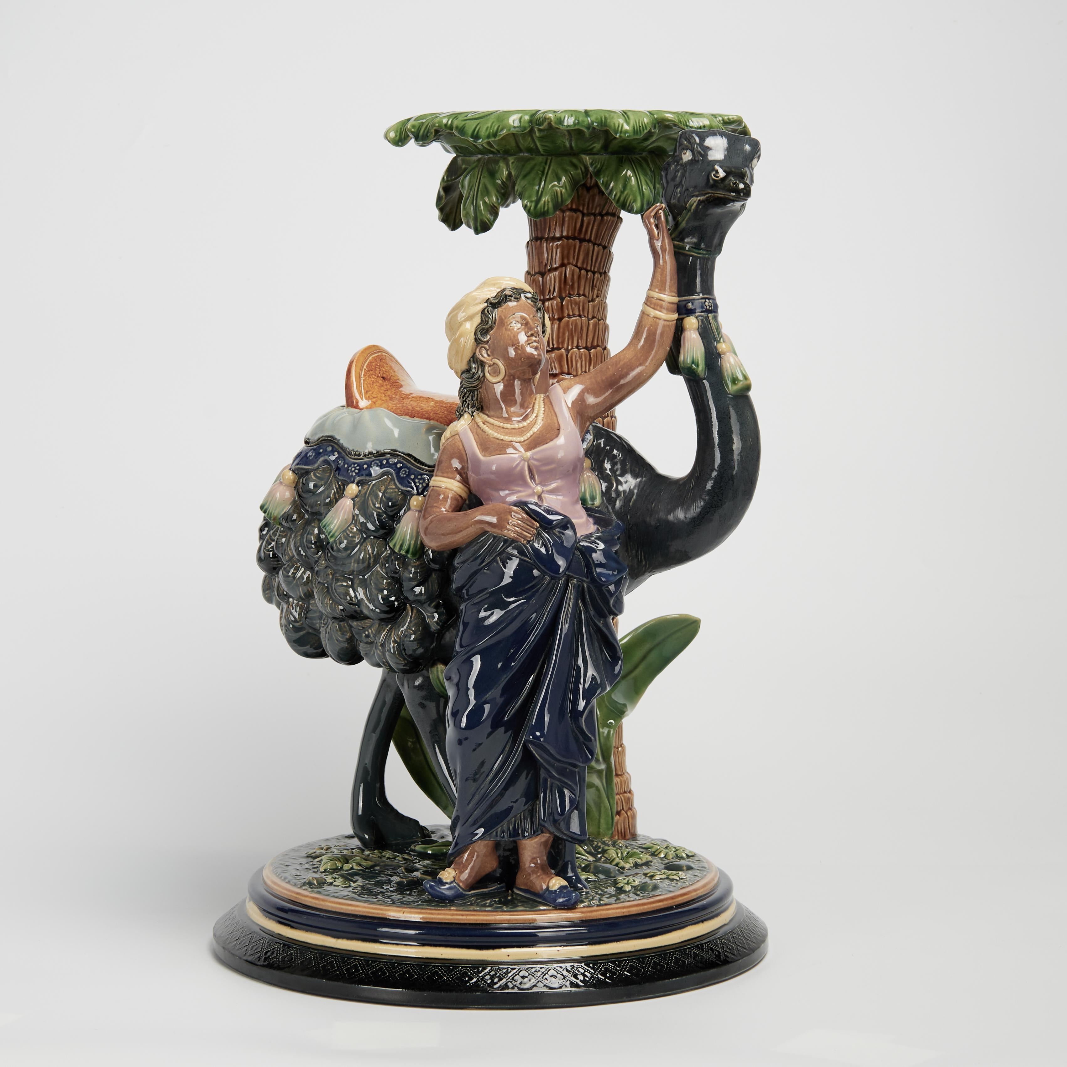 Standout 19th century majolica pedestal handcrafted in terra cotta. In an orientalist theme with a woman and an ostrich under a palm tree, decorated and glazed. Signed G & S 1847 on the bottom.