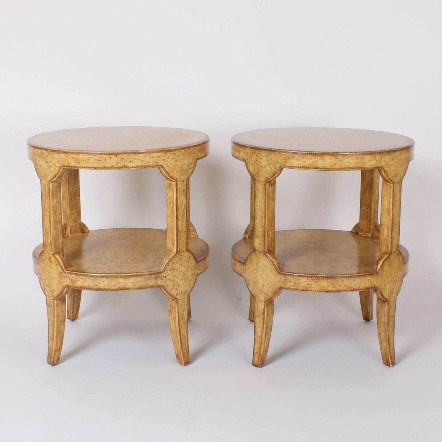 Chic pair of mid century Maitland Smith two tiered end tables or stands entirely covered in faux ostrich skin. The form is a modern stylized interpretation of directoire. Can be used with or without glass tops.