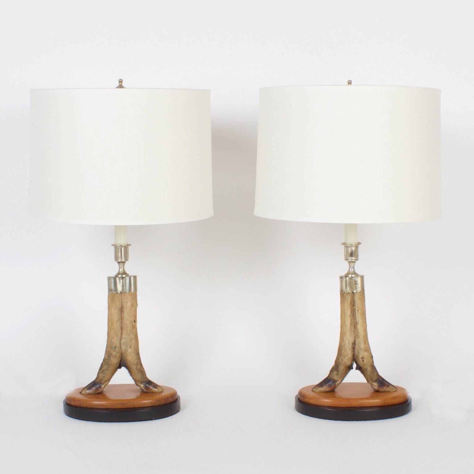 Vintage pair of custom English deer hoof table lamps with silver plated candle cups and hardware, presented on custom double plinths. Newly wired. Possibly Rowland Ward.

 