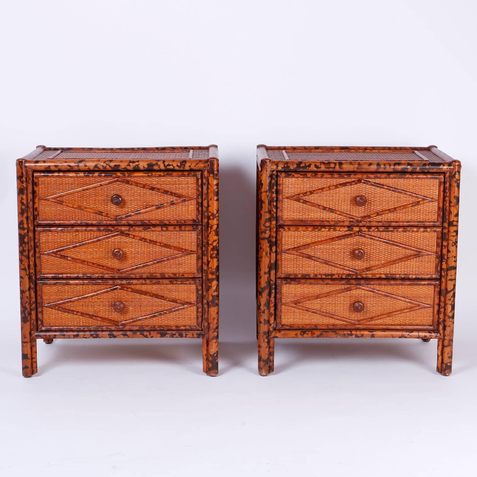 
Handsome mid century pair of three-drawer rattan style nightstands or tables with a robust organic palette composed of faux burnt bamboo and grass cloth. Originally sold at Bloomingdales as noted on the plaque in a drawer.

Chests or bedside tables