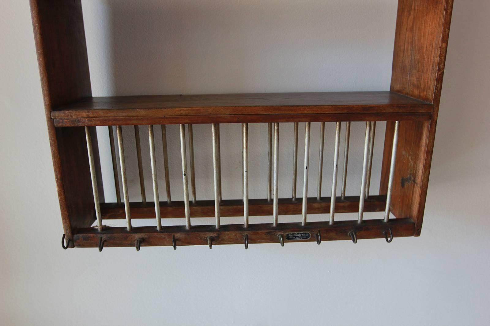 Rustic wall hanging dish rack with iron hooks.